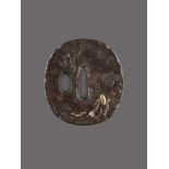 A FINE IRON TSUBA WITH SARUMAWASHI Iron with gold and copperJapan, Edo period (1615-1868)Of Naga