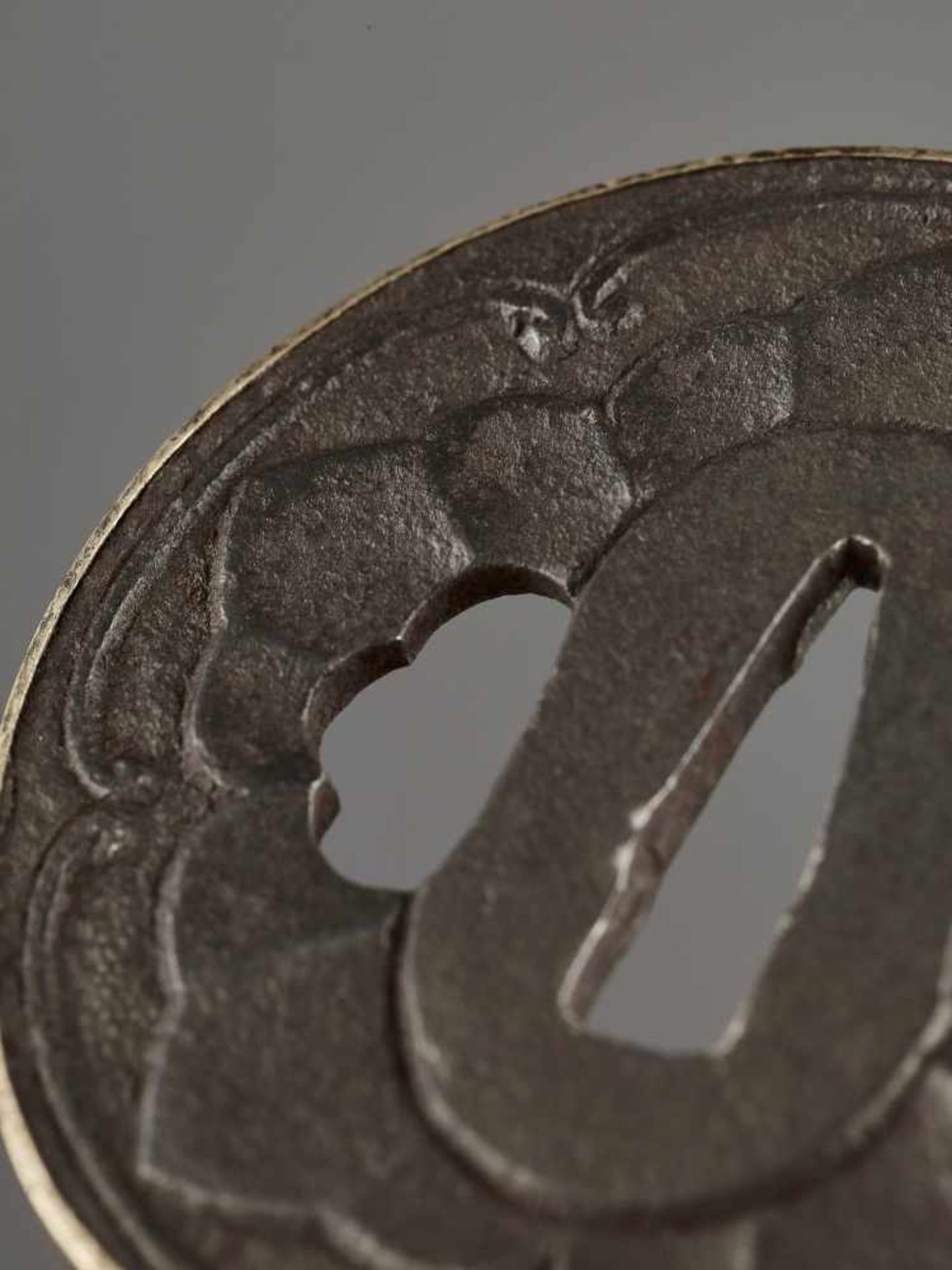 AN IRON TSUBA WITH MON CREST IronJapan, Edo period (1615-1868)Of Maru Gata shape with a raised and - Image 2 of 4