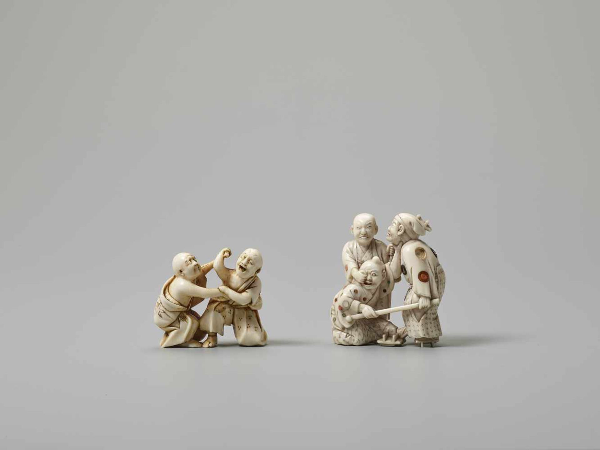 TWO IVORY NETSUKE OF BLIND MEN FIGHTING Unsigned, one with inlaysJapan, Meiji period (1868-1912)