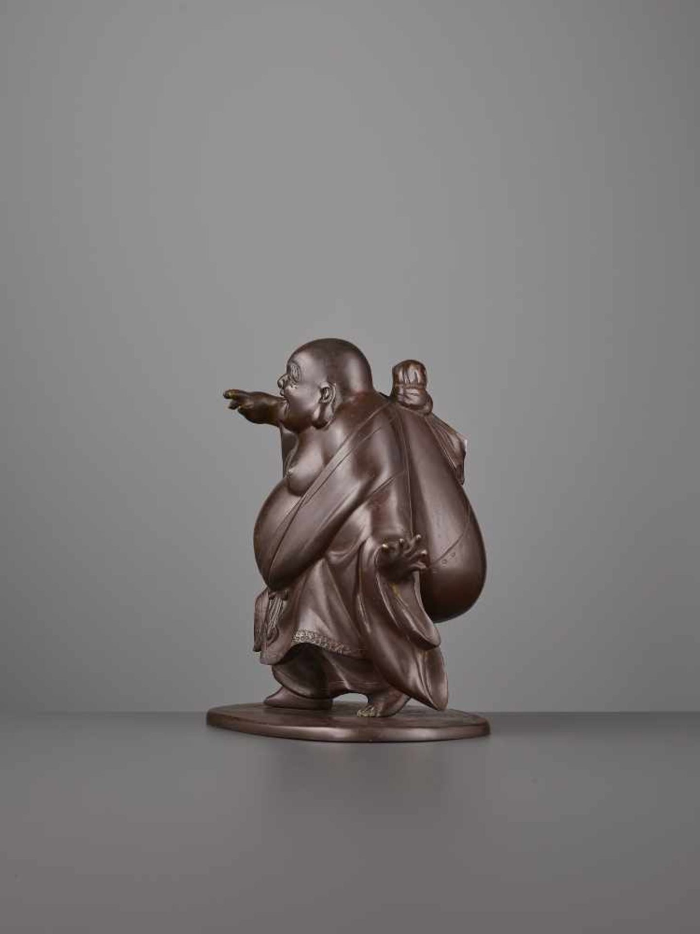 A CHARMING BRONZE OF HOTEI Japan, Meiji period (1868-1912). The bronze figure with a subtle maroon - Image 7 of 8