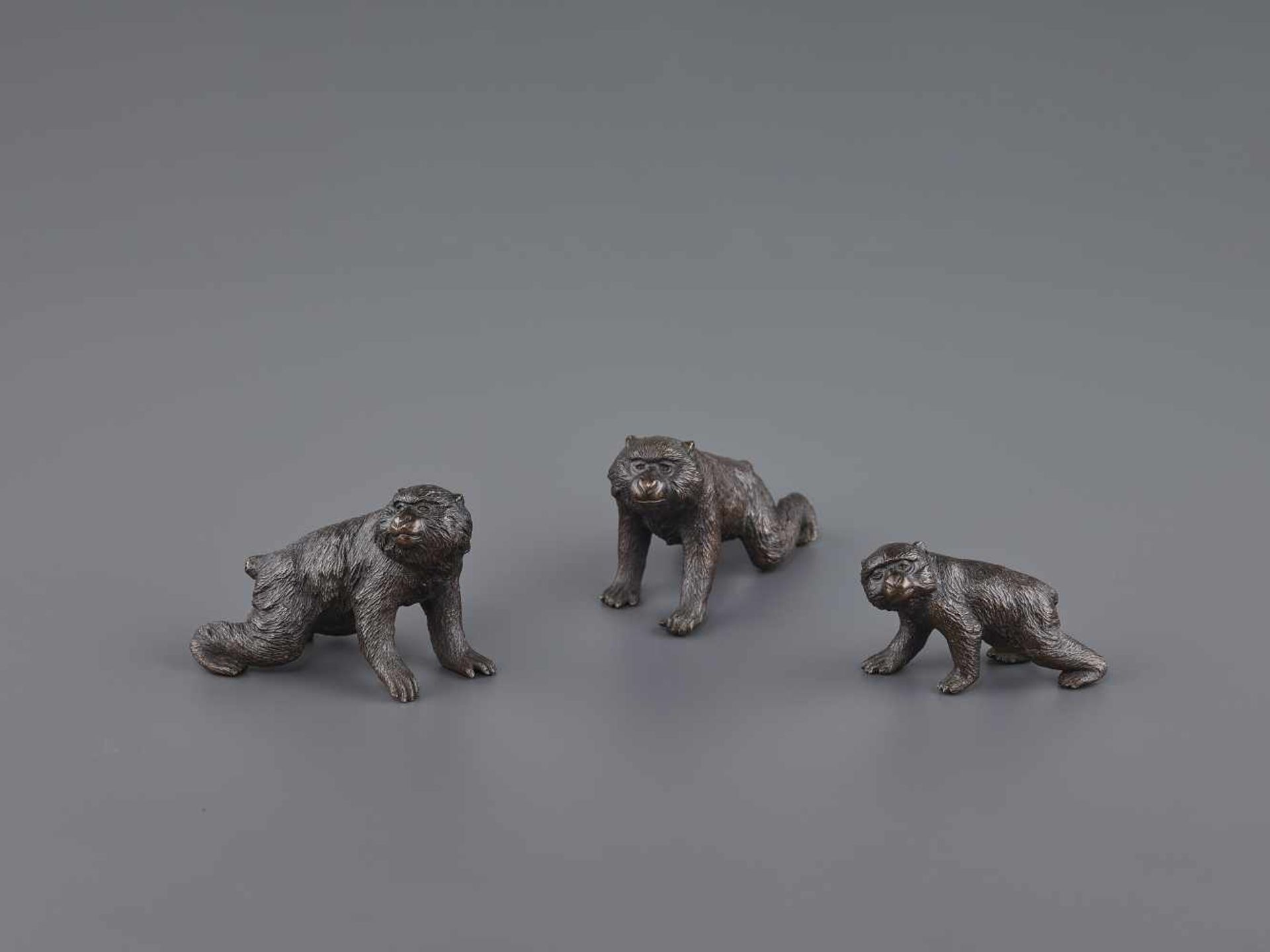 A SEIYA BRONZE GROUP OF MACAQUES Japan, Meiji period (1868-1912). All three monkeys bearing the