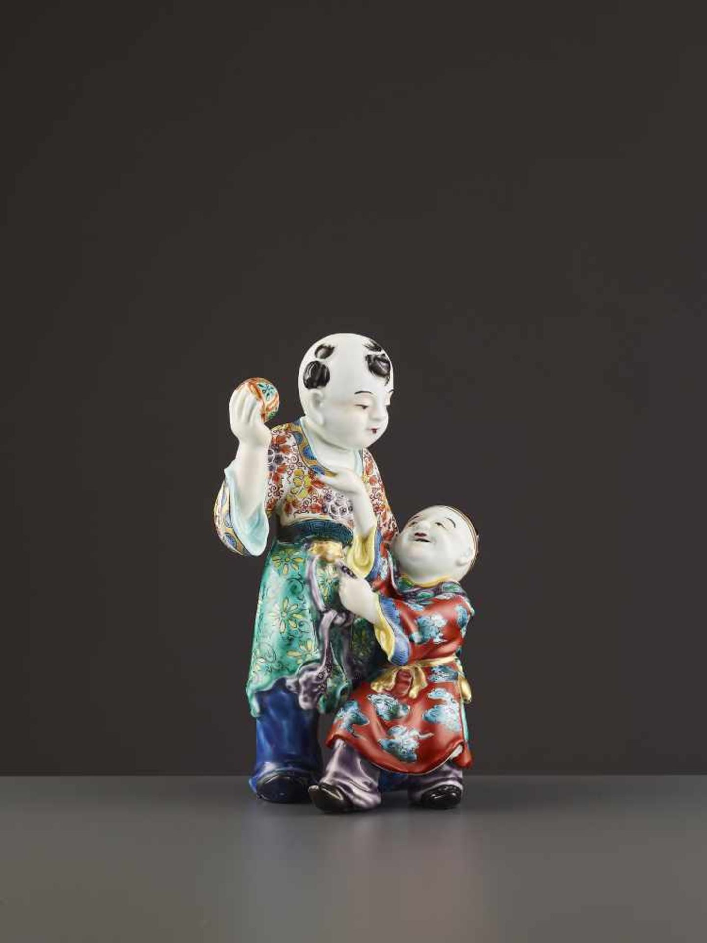 AN ARITA PORCELAIN KARAKO FIGURE Japan, Meiji period (1868-1912). Neatly potted porcelain statue - Image 2 of 9