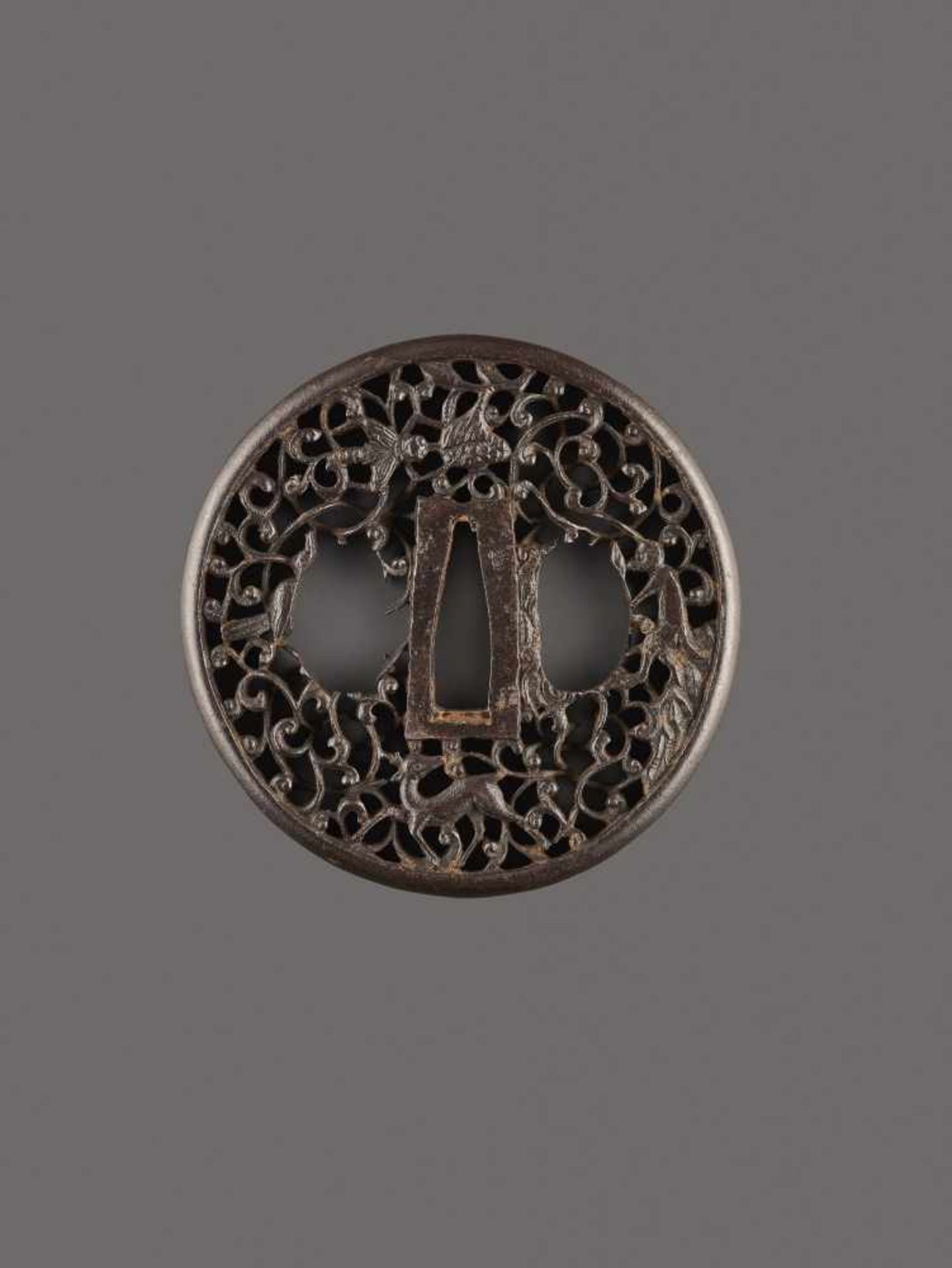 AN IRON TSUBA WITH MONKEY, LOTUS AND DEER Unsigned, patinated ironJapan, Edo period (1615-1868)Of