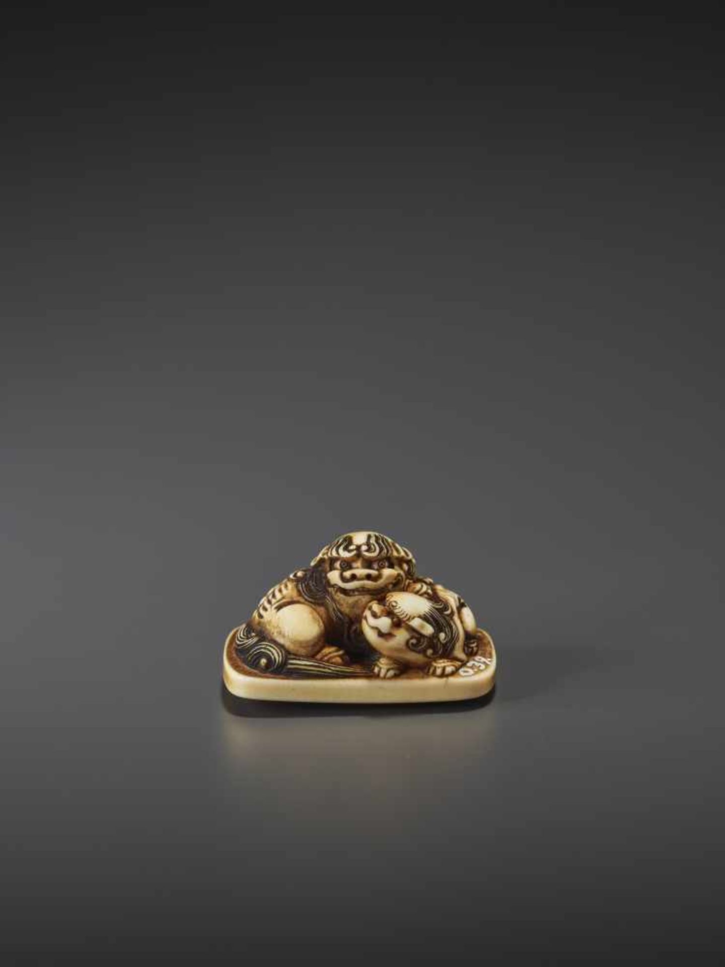 A FINE IVORY NETSUKE OF A SHISHI AND CUB IN THE MANNER OF RENSAI Unsigned, in the manner of