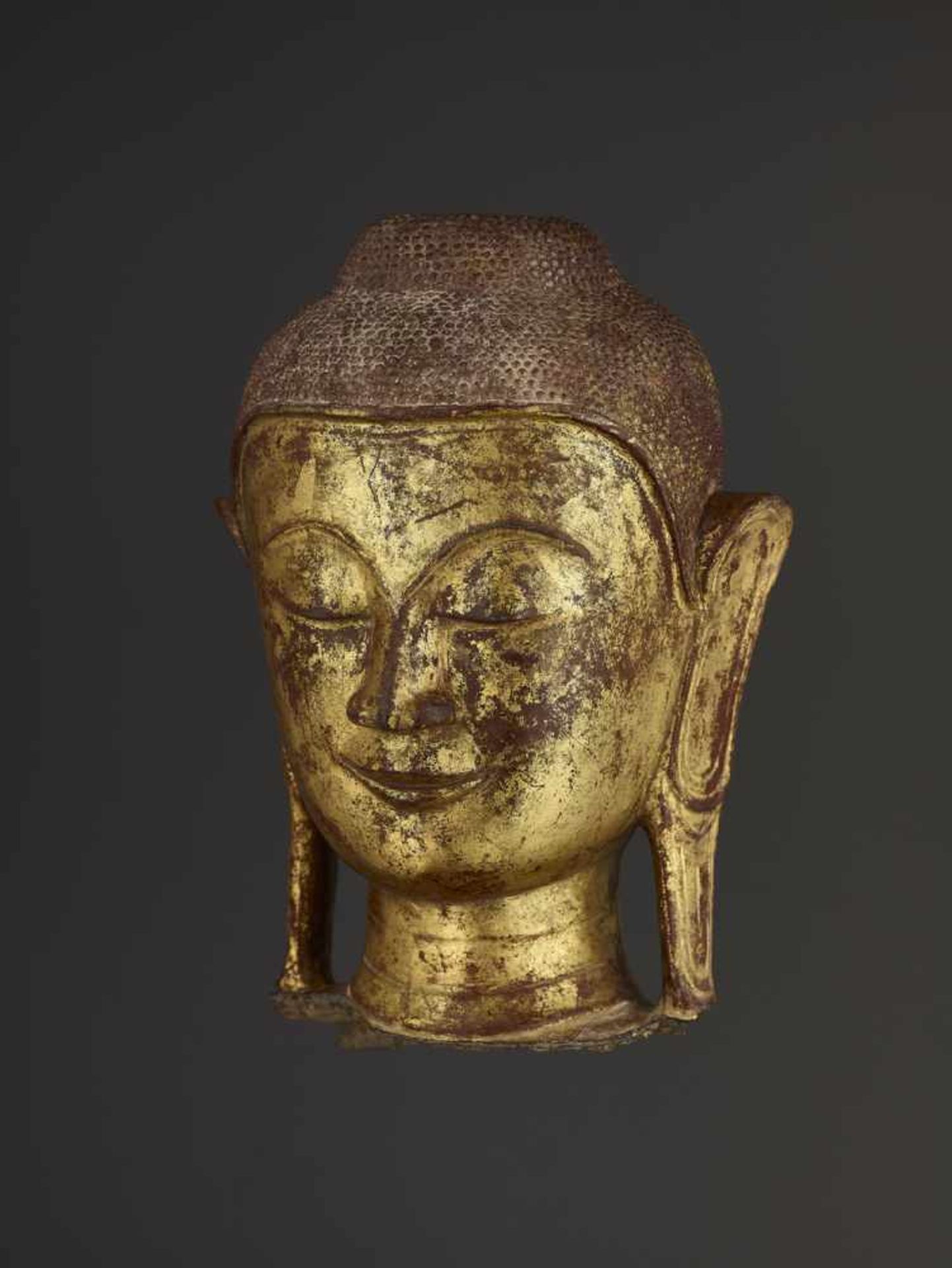 A RARE DRY LACQUER HEAD OF BUDDHA Burma, 18th – earlier 19th century. A large and finely gilt