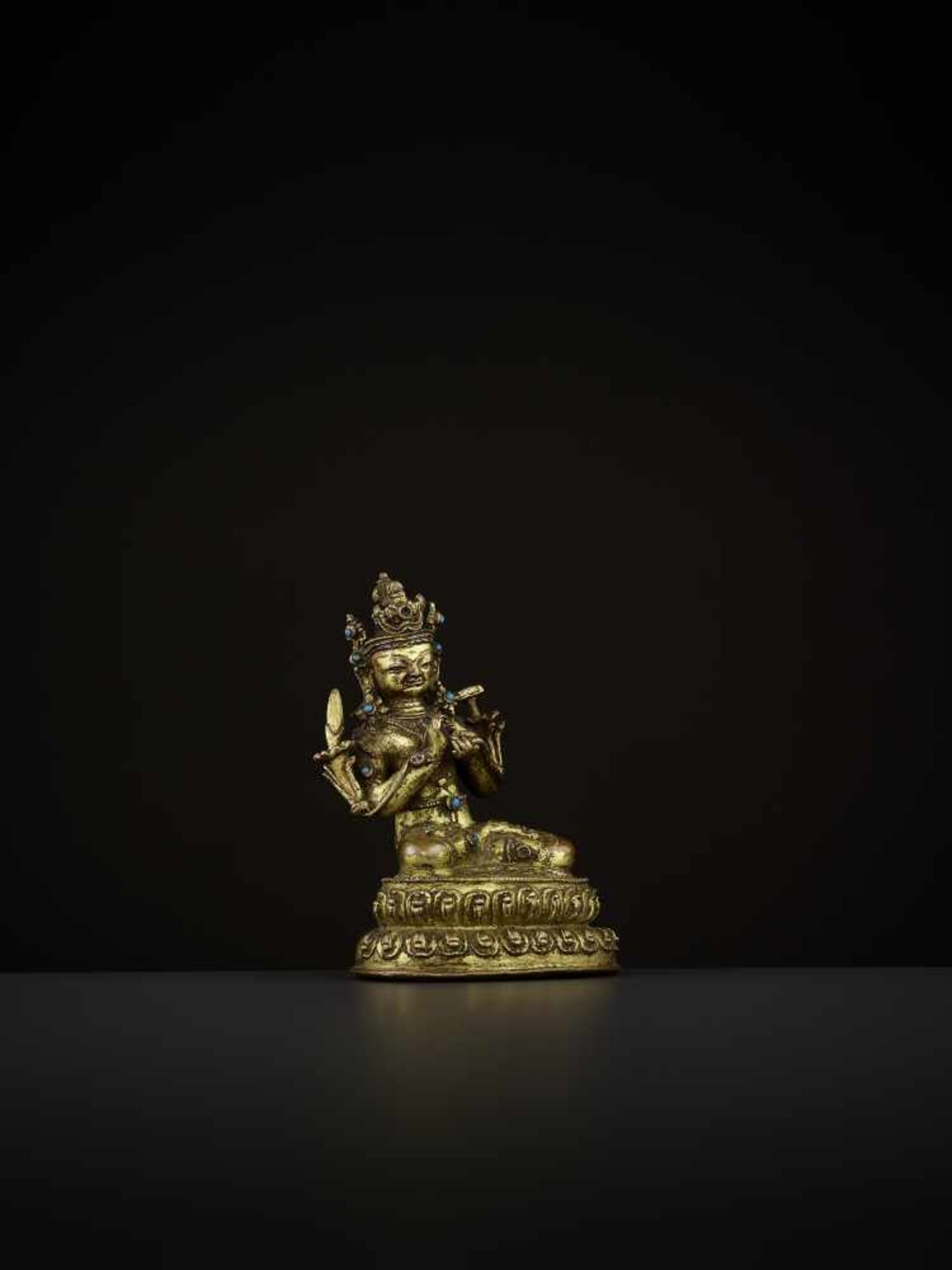 A GILT-BRONZE OF MANJUSHRI Tibet, 14th-15th century. The bodhisattva is seated in vajrasana on a - Image 6 of 9