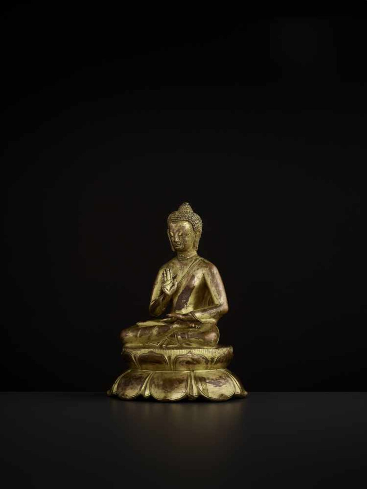 A BUDDHA AMOGHASIDDHI, NEPAL 17TH CENTURY The heavily cast gilt copper-alloy figure is seated in - Image 4 of 14