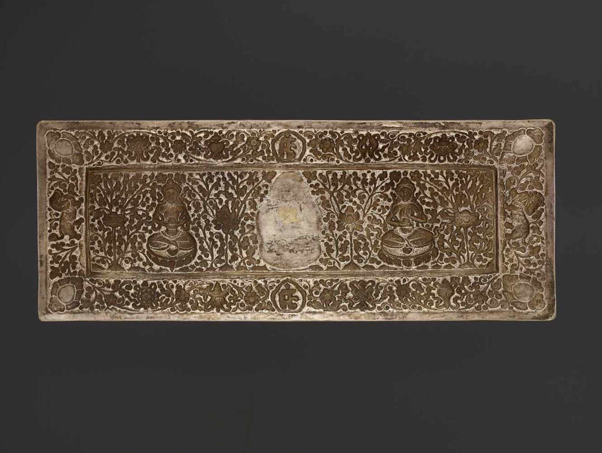 A SILVER REPOUSSÉ MANUSCRIPT COVER Tibet, late 18th – earlier 19th century. A gilt Buddha Shakyamuni - Image 5 of 5