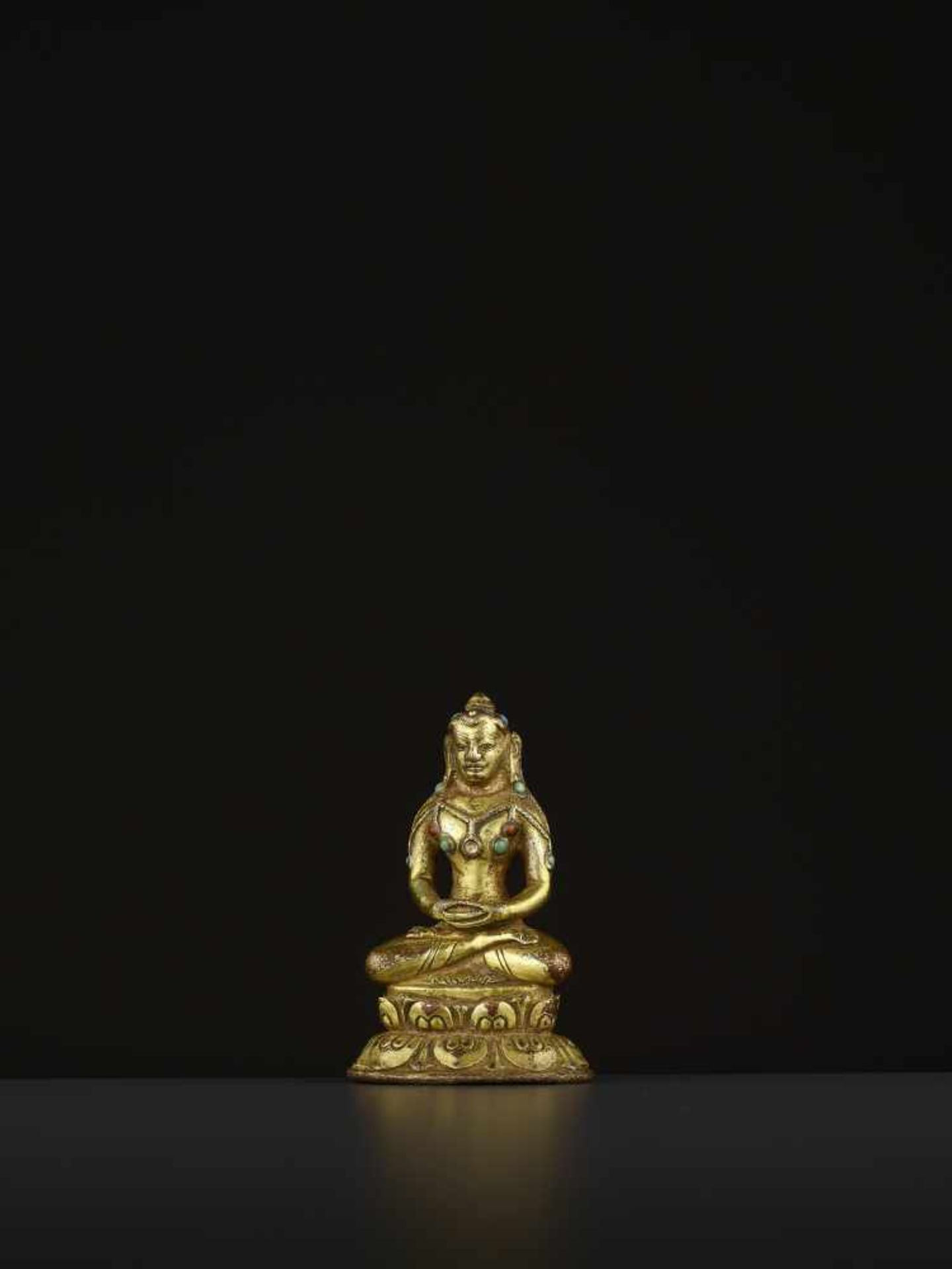 A GILT BRONZE MAHASIDDHA VIRUPA, 16TH CENTURY Tibet. Seated in dhyanasana on a double lotus base,