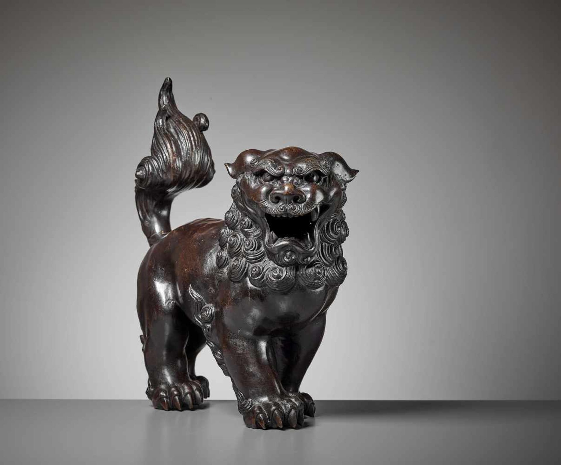 A VERY LARGE BUDDHIST LION BRONZE, MING China, 17th century. Heavily cast bronze of a roaring