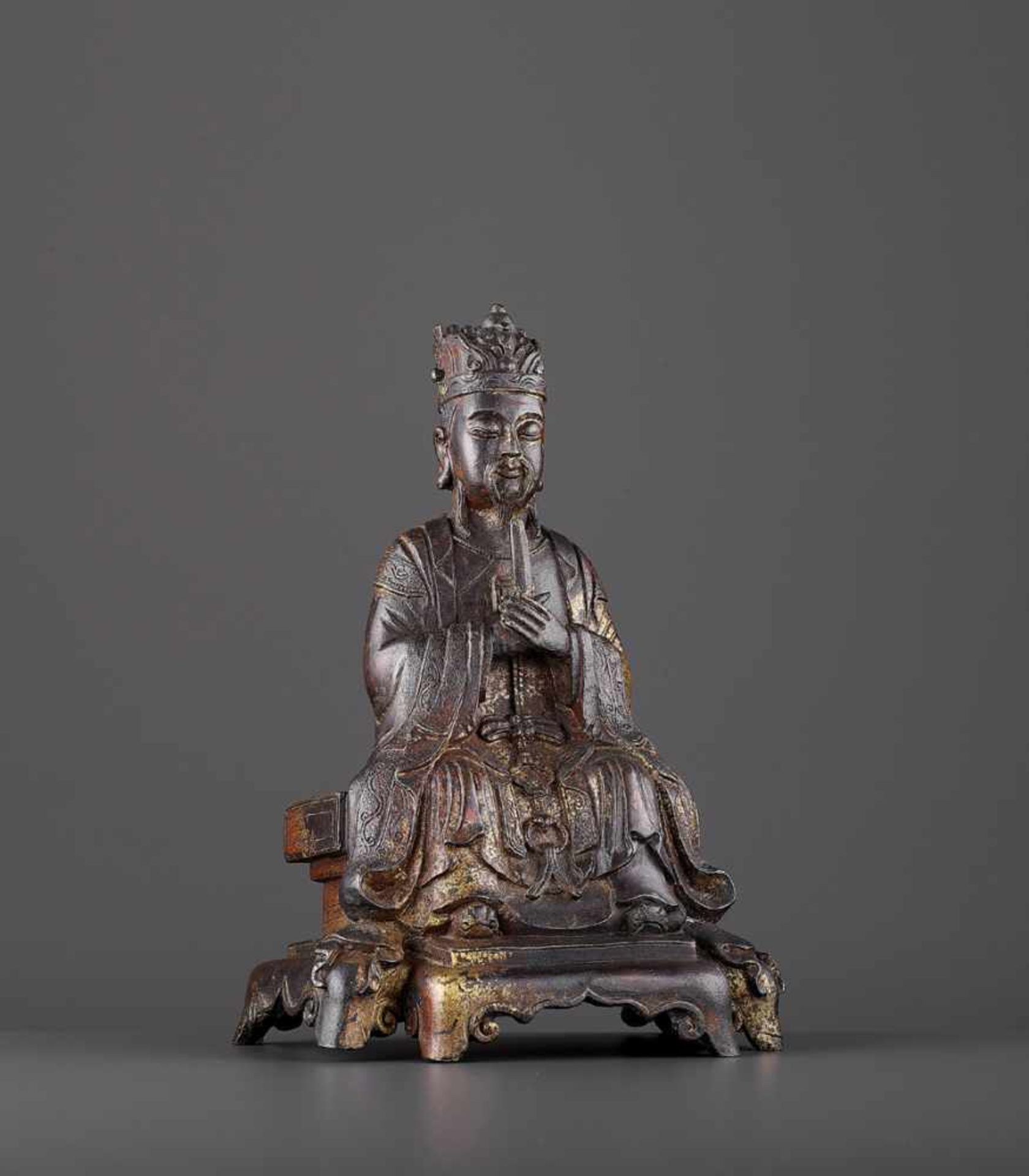 A BRONZE OF A DAOIST IMMORTAL, MING China, 16th -17th century. The sage cast seated as a dignitary