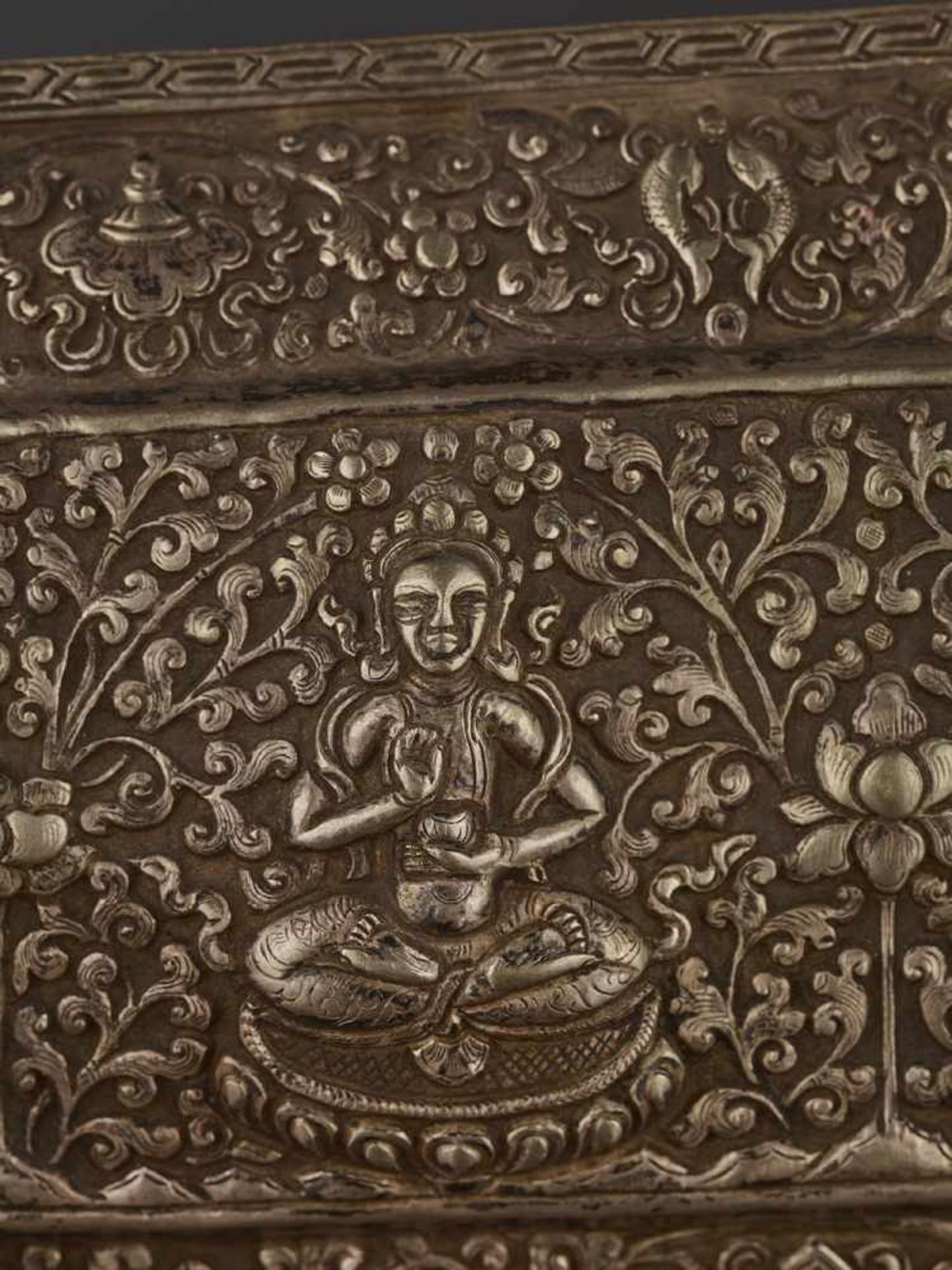 A SILVER REPOUSSÉ MANUSCRIPT COVER Tibet, late 18th – earlier 19th century. A gilt Buddha Shakyamuni - Image 4 of 5