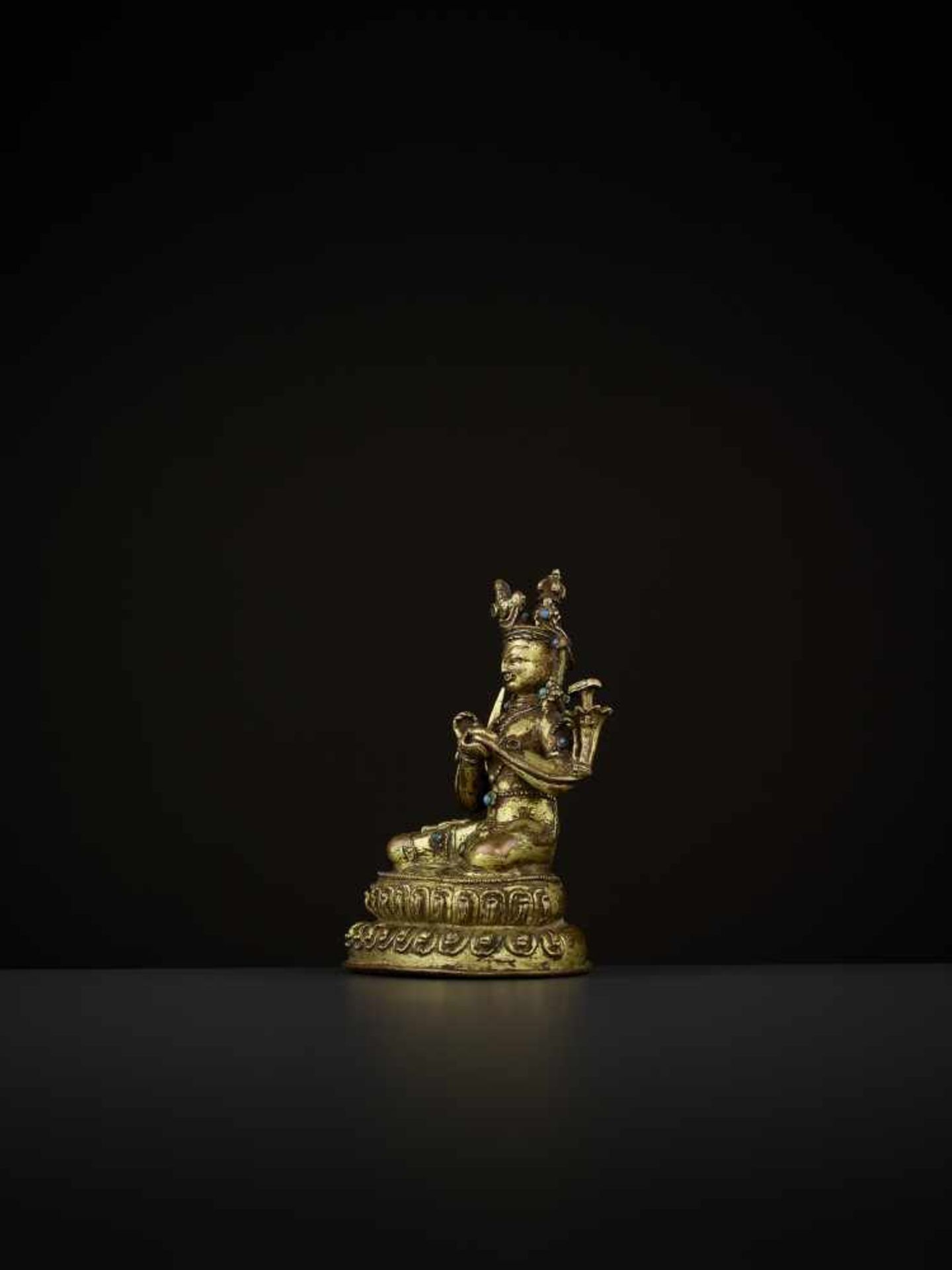 A GILT-BRONZE OF MANJUSHRI Tibet, 14th-15th century. The bodhisattva is seated in vajrasana on a - Image 3 of 9