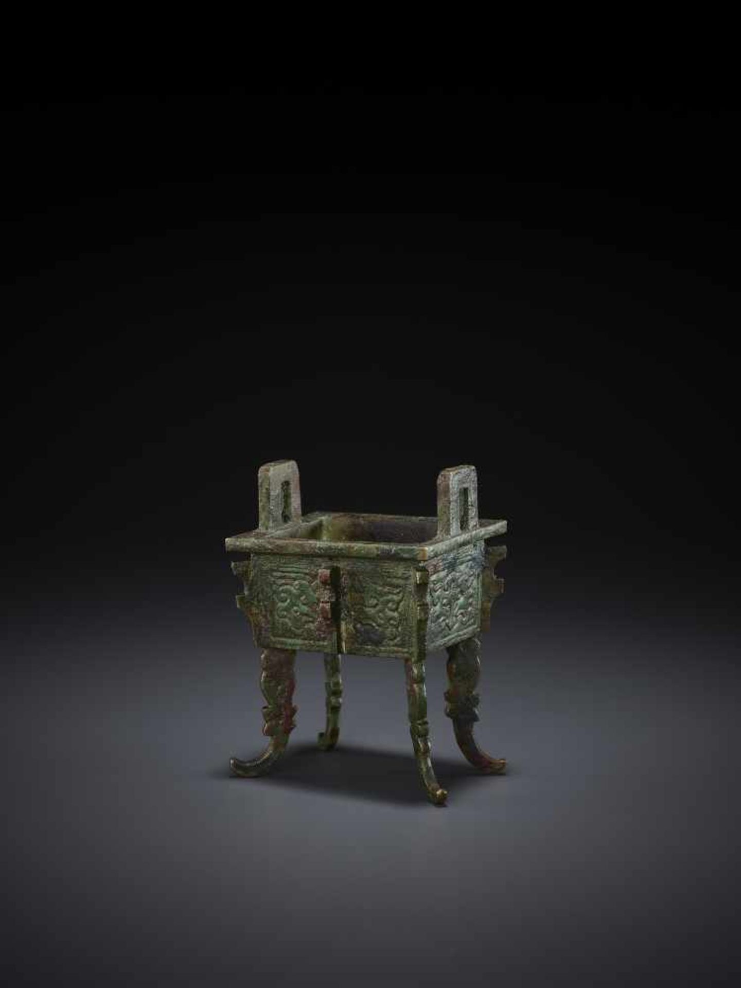 A MINIATURE BRONZE MODEL OF A FANGDING China, Qing dynasty. The miniaturized ritual food vessel - Image 4 of 10