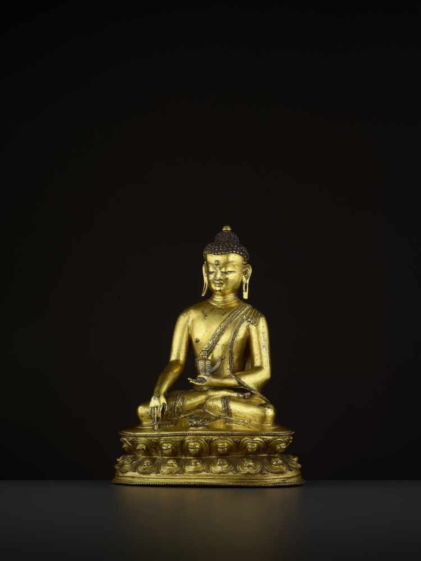 A GILT BRONZE BUDDHA VAJRASANA Tibet, 14th - 16th century. A superb fire-gilt bronze of Buddha