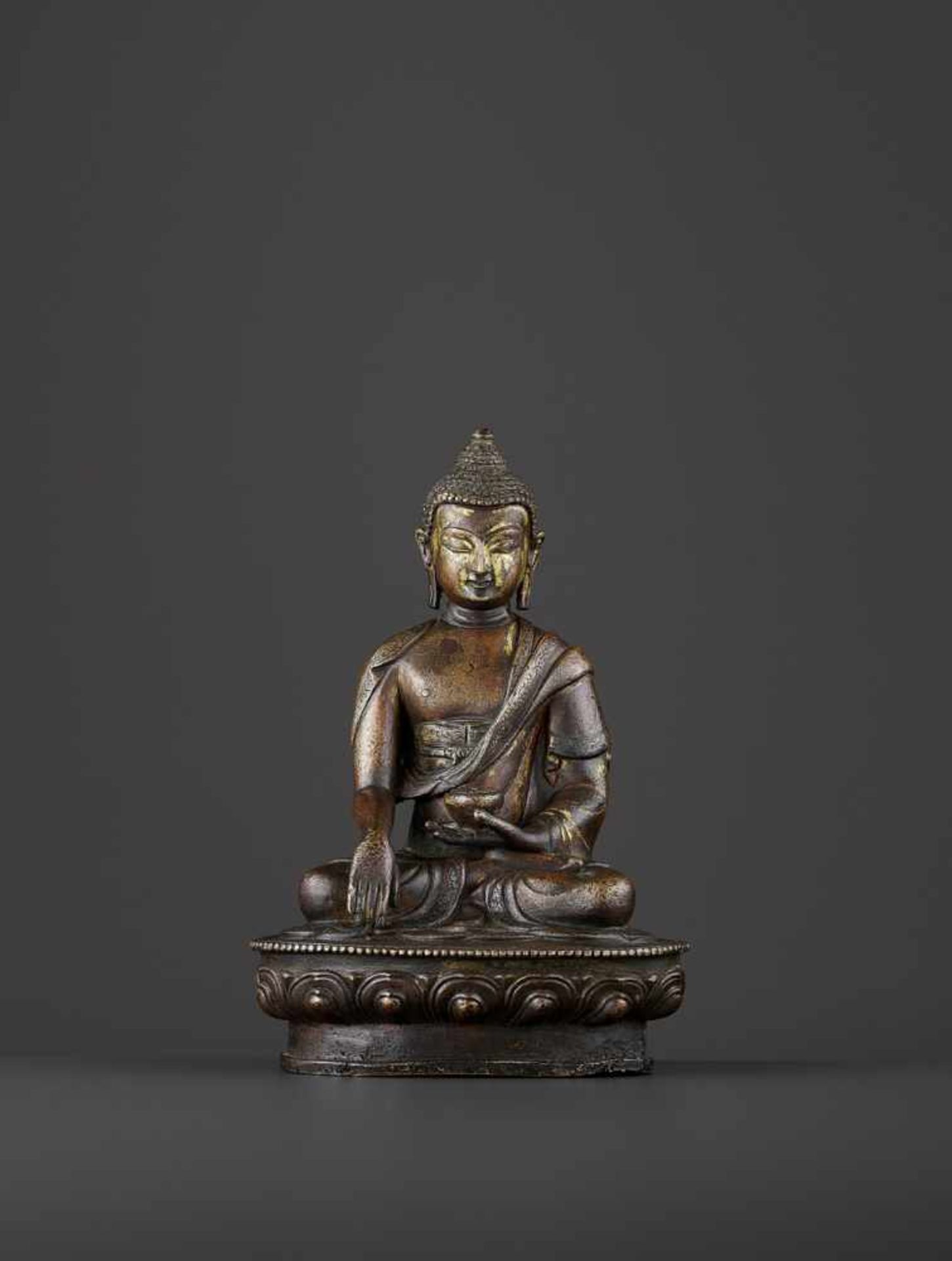 A BRONZE BUDDHA SHAKYMUNI, QING China, 18th century. The figure seated on a beaded lotus base in