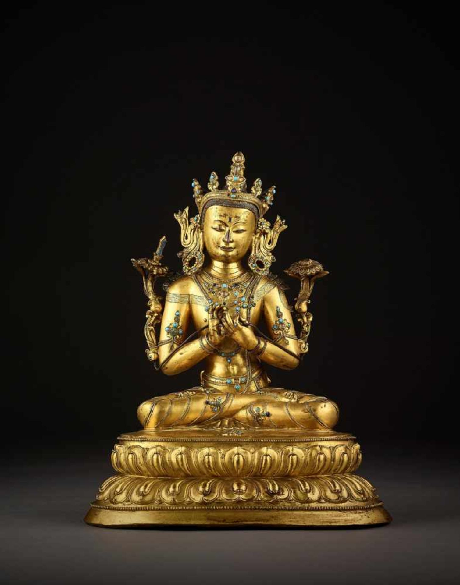 AN EXTREMELY RARE GILT-BRONZE FIGURE OF MANJUSRI, TIBET 14TH CENTURY