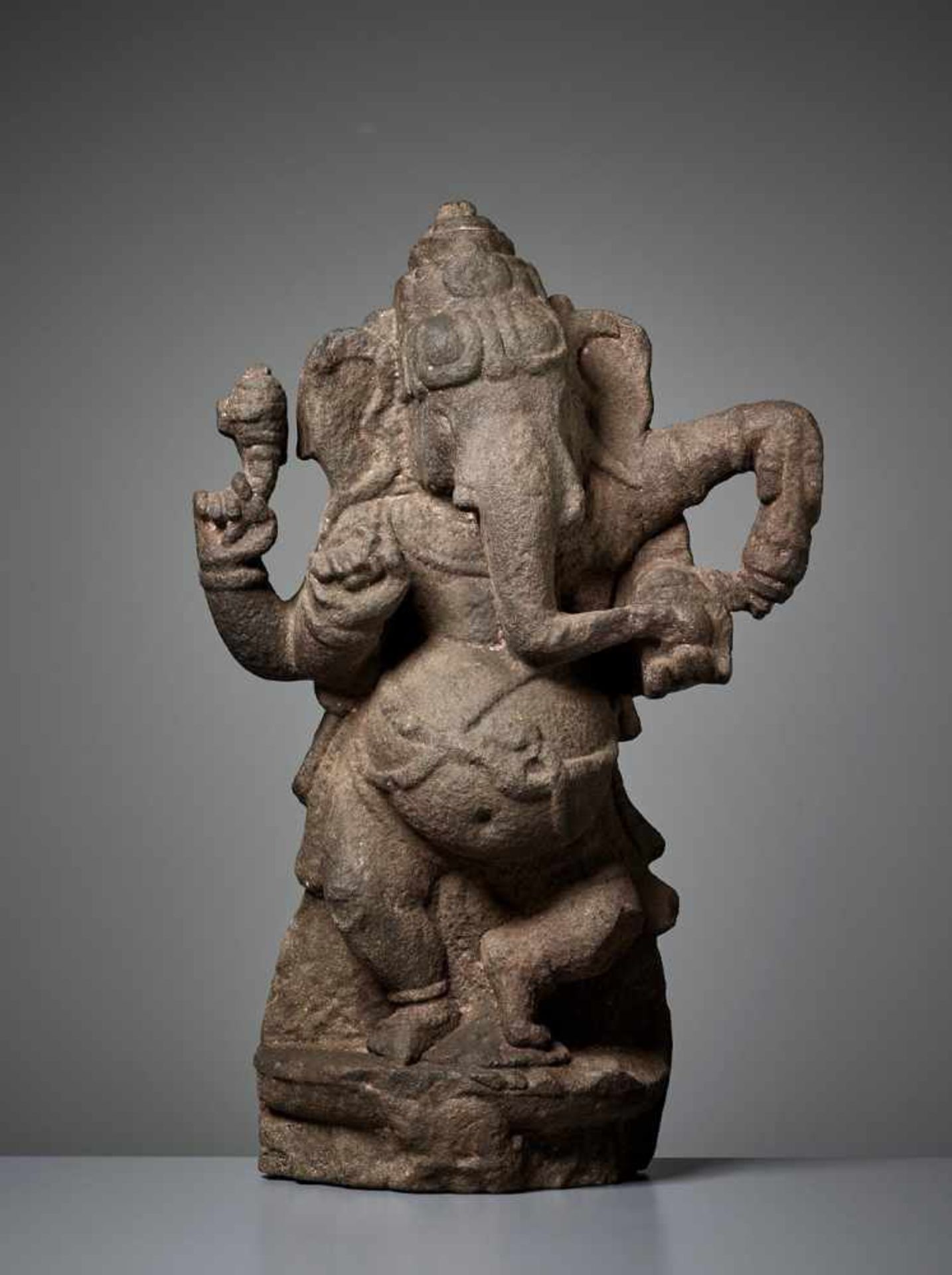 A RARE SANDSTONE STELE OF GANESHA India, 11th – 13th century. Dancing with one leg raised and his