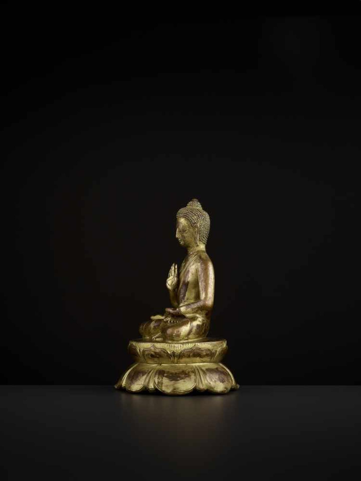 A BUDDHA AMOGHASIDDHI, NEPAL 17TH CENTURY The heavily cast gilt copper-alloy figure is seated in - Image 5 of 14