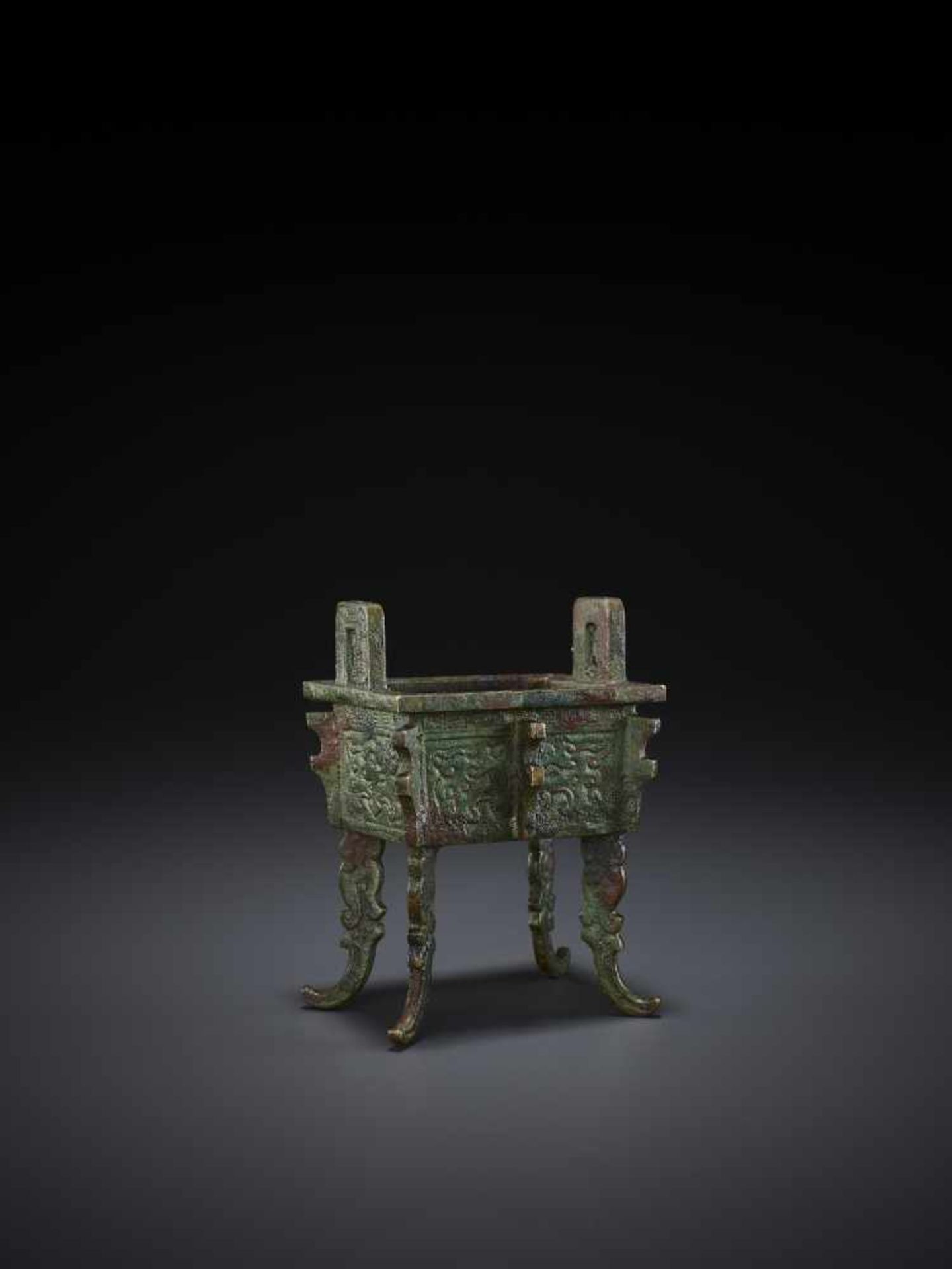 A MINIATURE BRONZE MODEL OF A FANGDING China, Qing dynasty. The miniaturized ritual food vessel