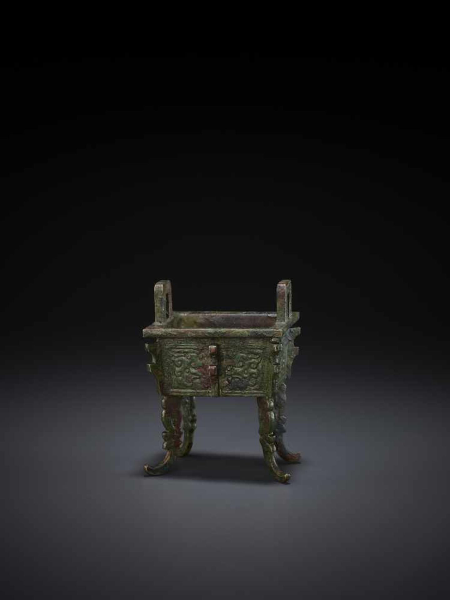 A MINIATURE BRONZE MODEL OF A FANGDING China, Qing dynasty. The miniaturized ritual food vessel - Image 2 of 10