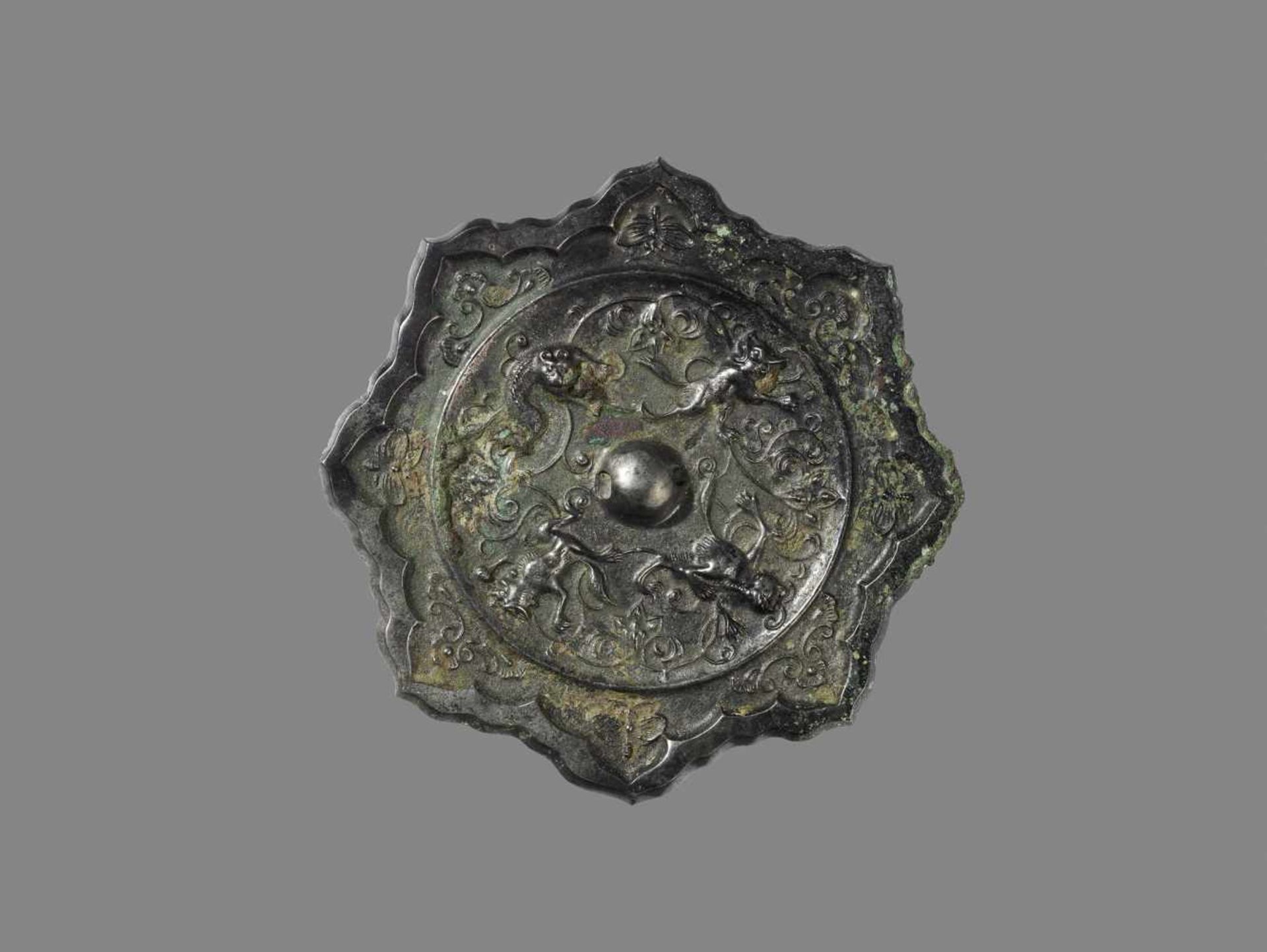 AN OCTAFOIL BRONZE MIRROR, TANG DYNASTY China, 618-907. Crisply cast in linghua shape (water