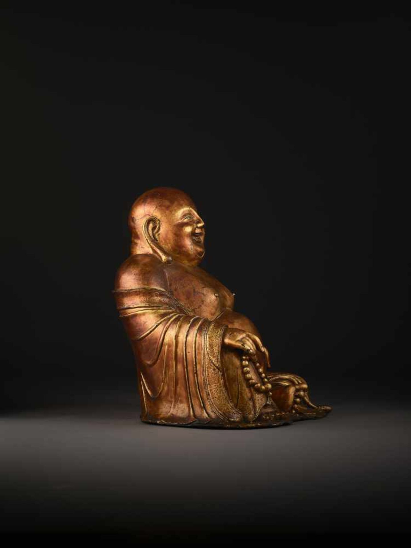 A LARGE GILT BRONZE FIGURE OF BUDAI China, 1368-1644. The smiling, corpulent figure is shown - Image 11 of 14