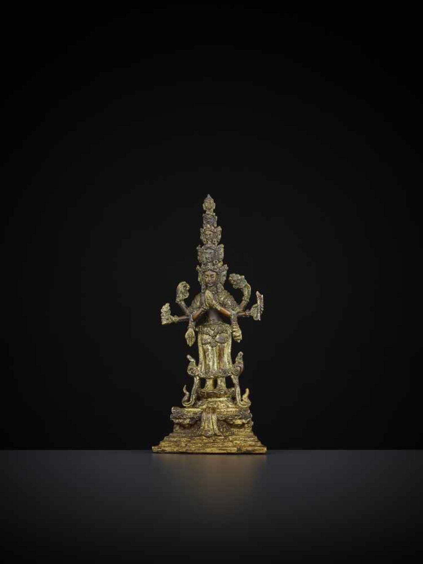 AN EKADASHAMUKHA BRONZE 18TH CENTURY Sino-Tibetan. Gilt and finely incised bronze with