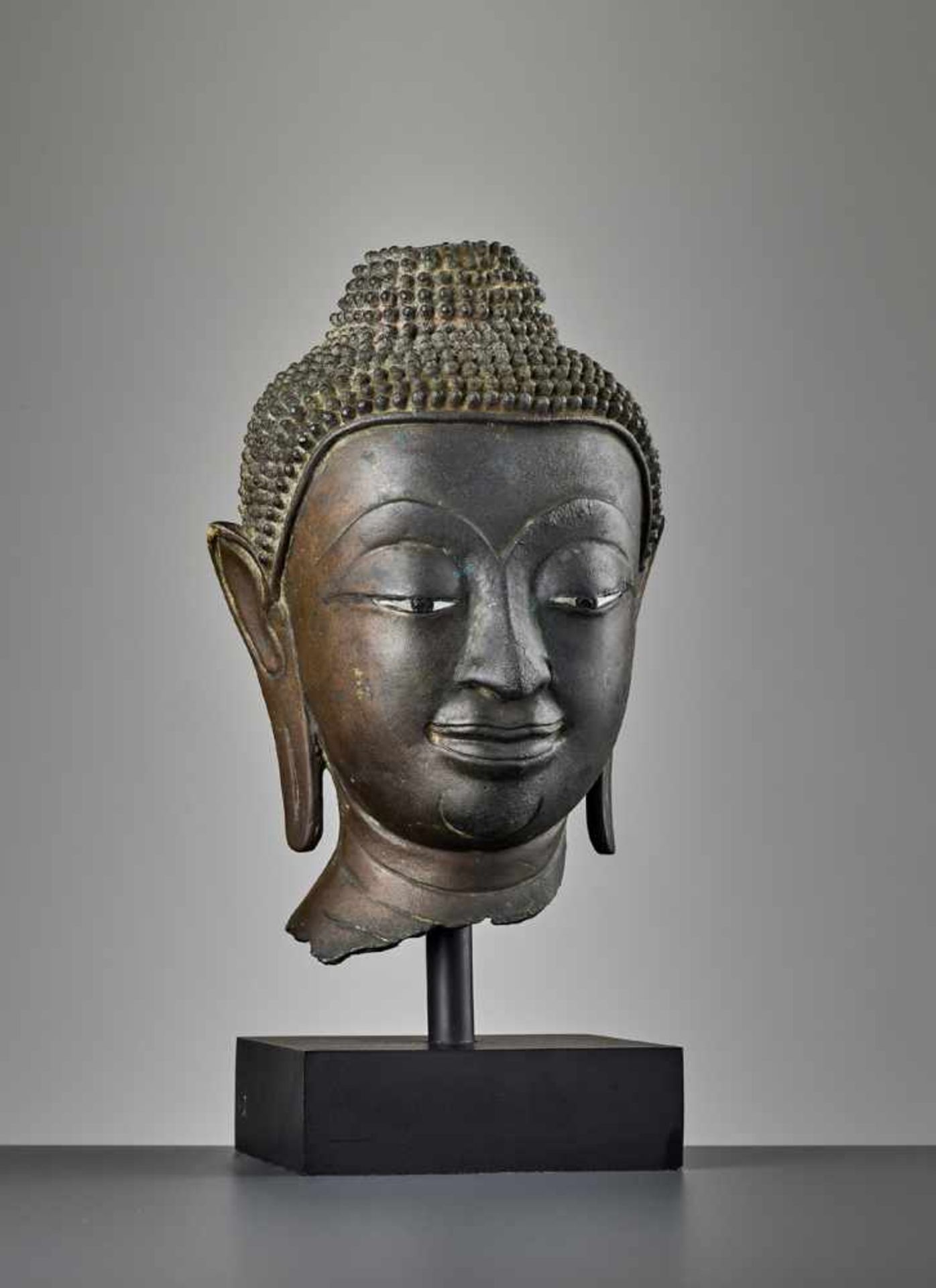 A SUKHOTHAI BRONZE HEAD OF BUDDHA, KAMPHAENG PHET Thailand, 15th century. Bronze with eyes inlaid in