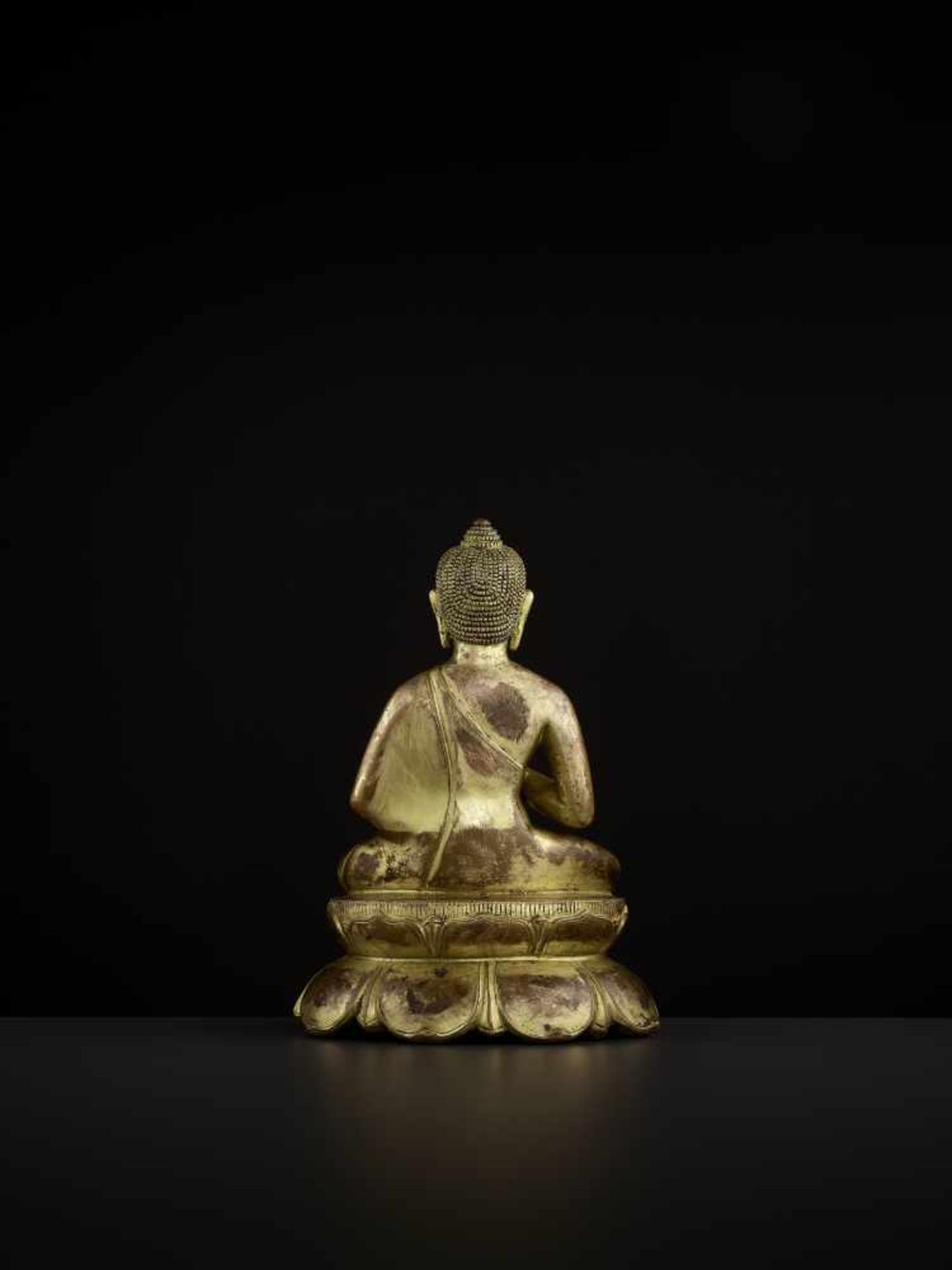 A BUDDHA AMOGHASIDDHI, NEPAL 17TH CENTURY The heavily cast gilt copper-alloy figure is seated in - Image 6 of 14