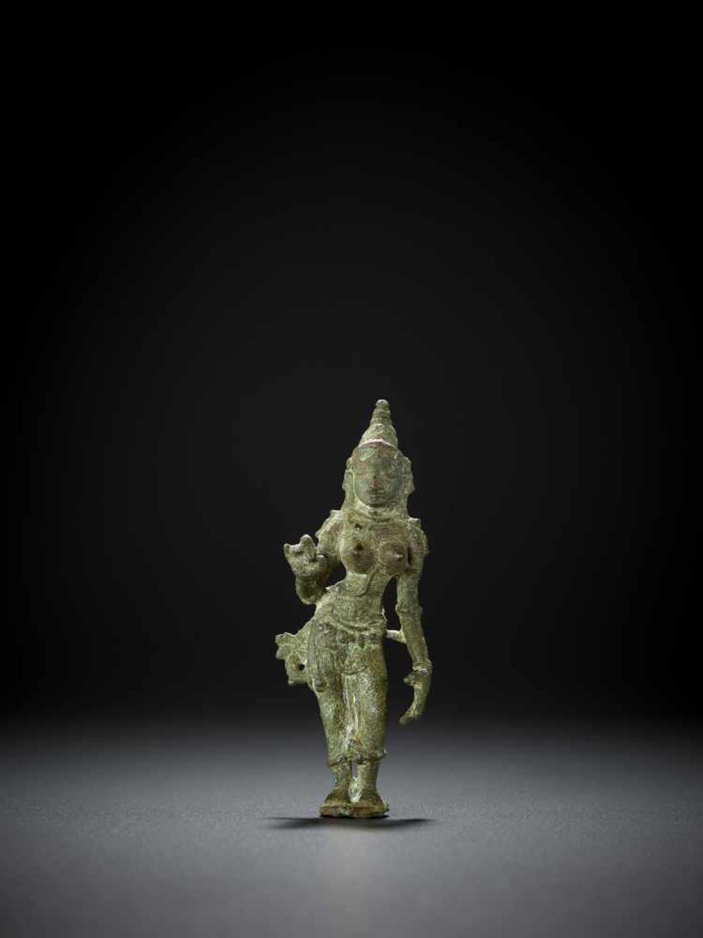 A BRONZE OF PARVATI, 13TH CENTURY South India, Chola period. Standing in graceful tribangha on a