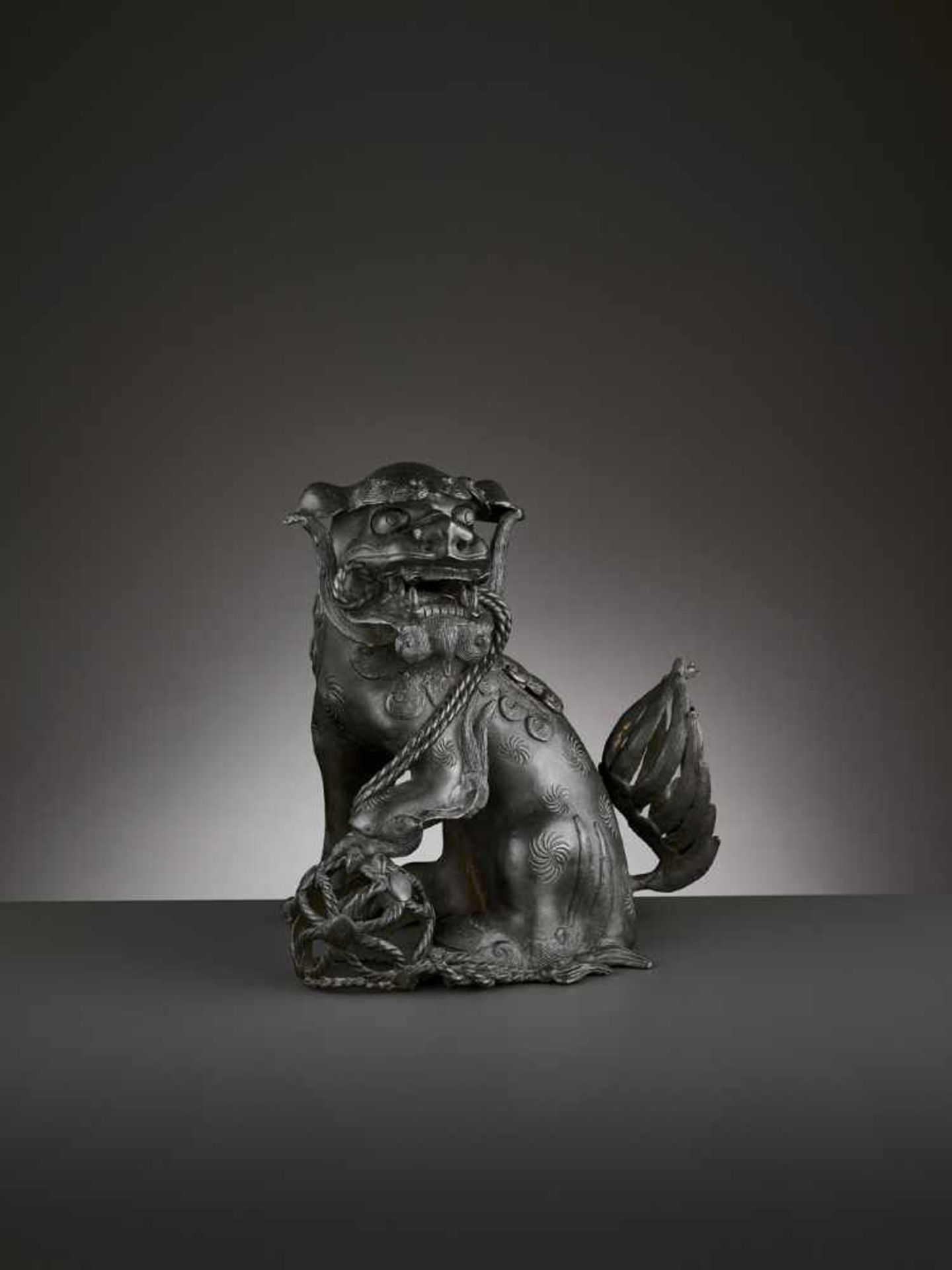 A BRONZE ‘BUDDHIST LION’ CENSER, MING China 17th century. Cast seated, the raised head with large