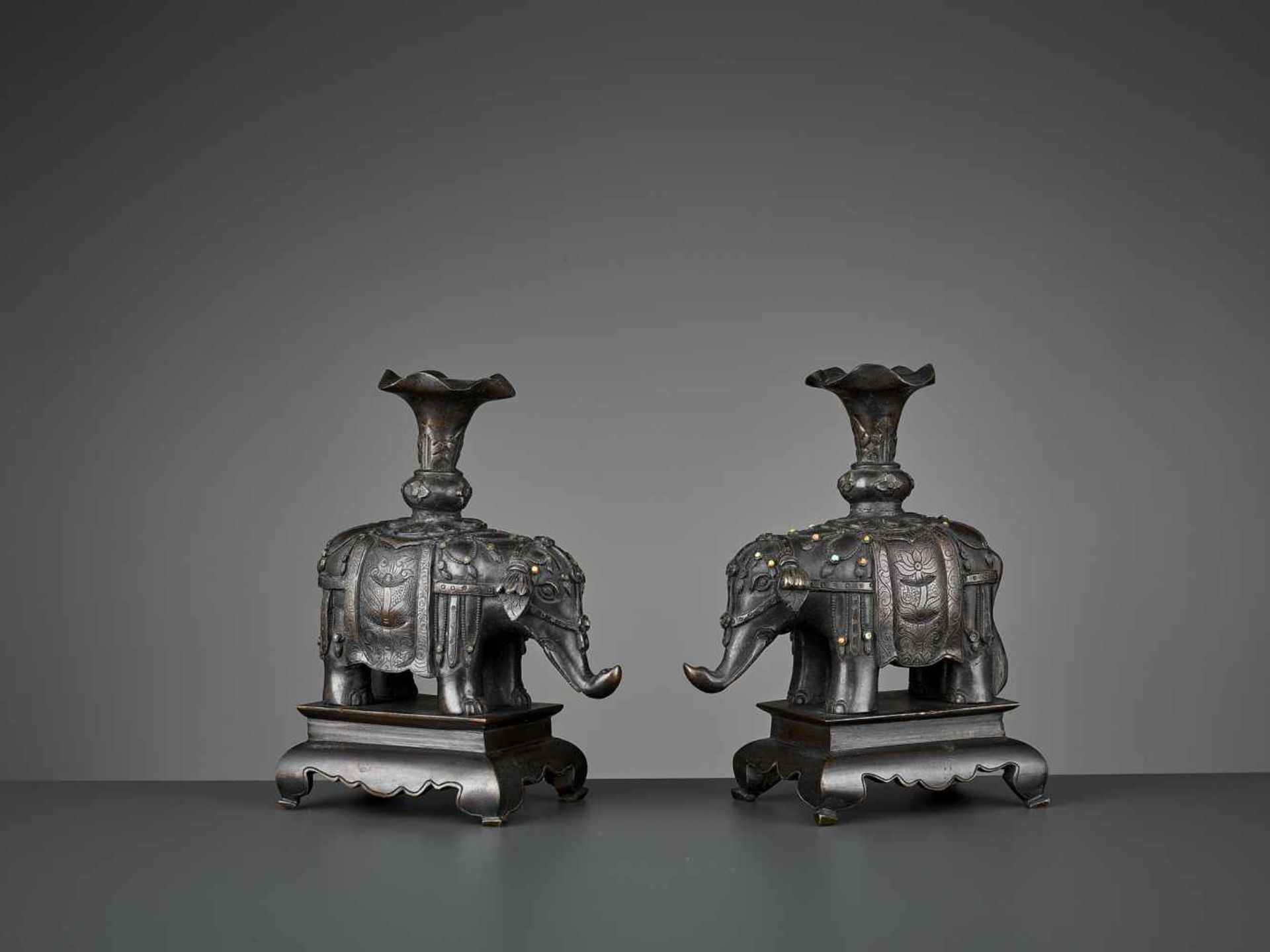 A PAIR OF CAPARISONED ELEPHANT BRONZES China, 17th-18th century. Shown on a stepped plinth with four