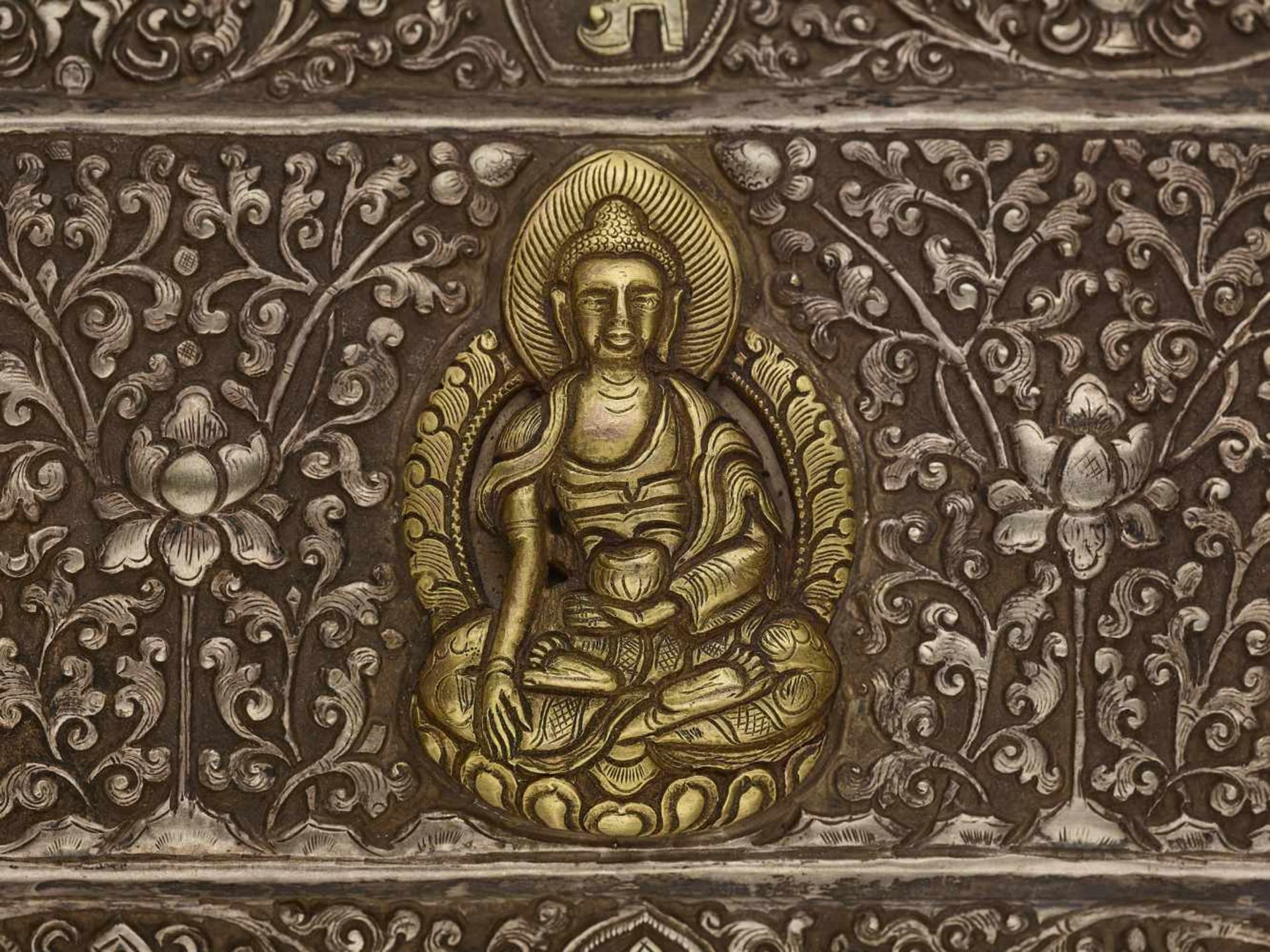 A SILVER REPOUSSÉ MANUSCRIPT COVER Tibet, late 18th – earlier 19th century. A gilt Buddha Shakyamuni - Image 2 of 5