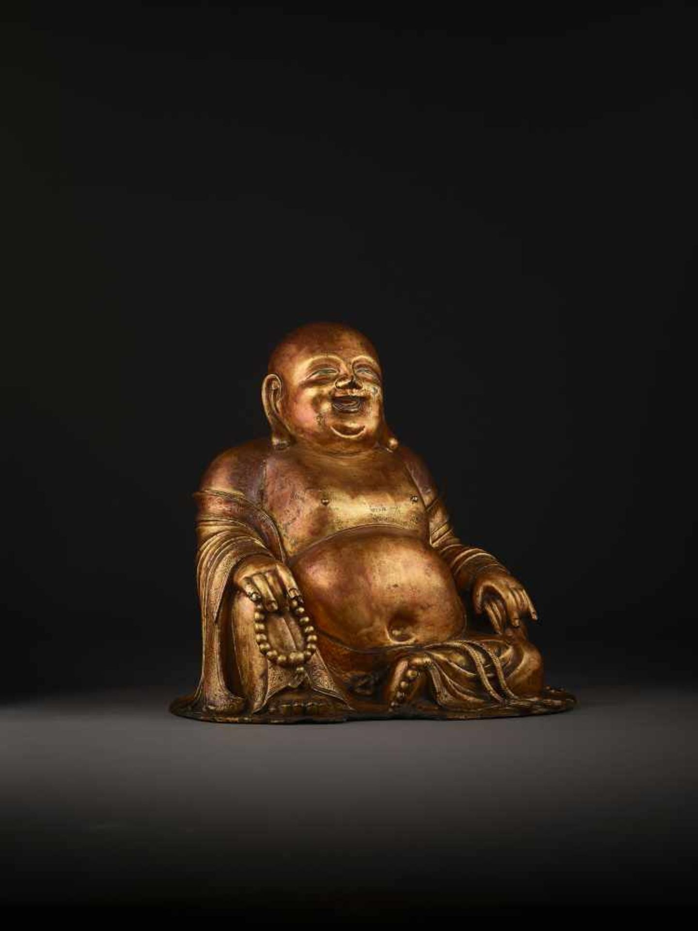 A LARGE GILT BRONZE FIGURE OF BUDAI China, 1368-1644. The smiling, corpulent figure is shown - Image 12 of 14