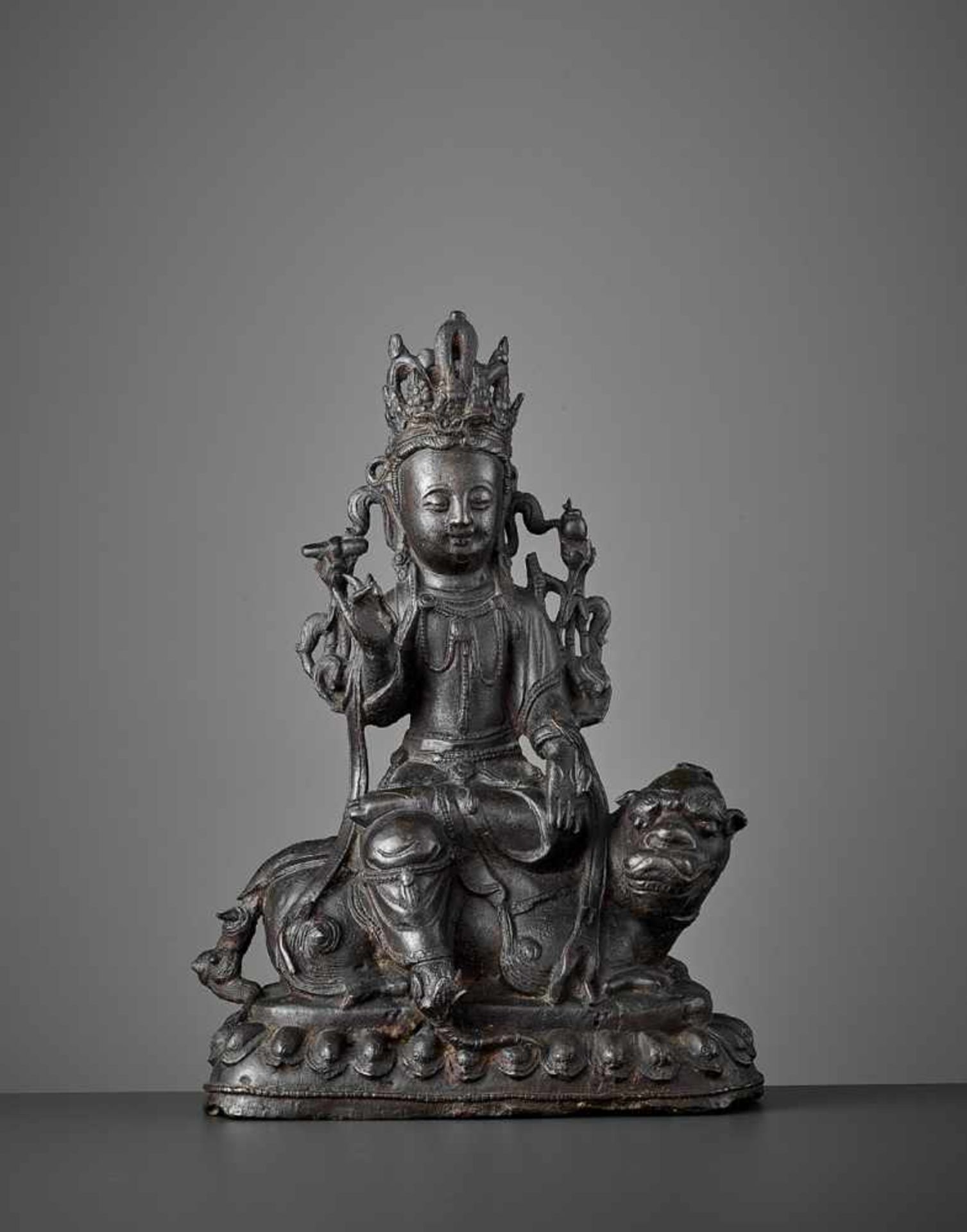 A BRONZE FIGURE OF WENSHU, MING DYNASTY China, 1368-1644. The bejeweled Wisdom Bodhisattva is cast