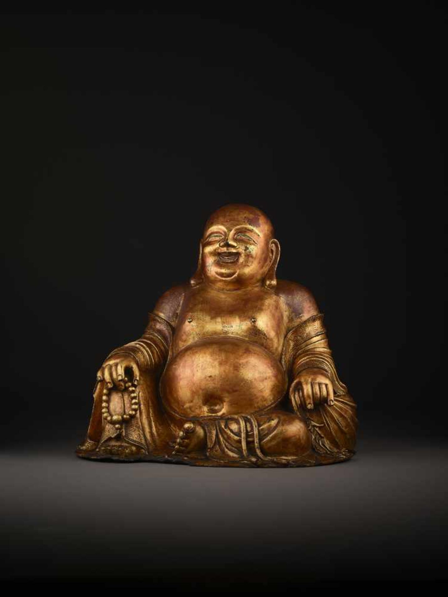 A LARGE GILT BRONZE FIGURE OF BUDAI China, 1368-1644. The smiling, corpulent figure is shown - Image 9 of 14