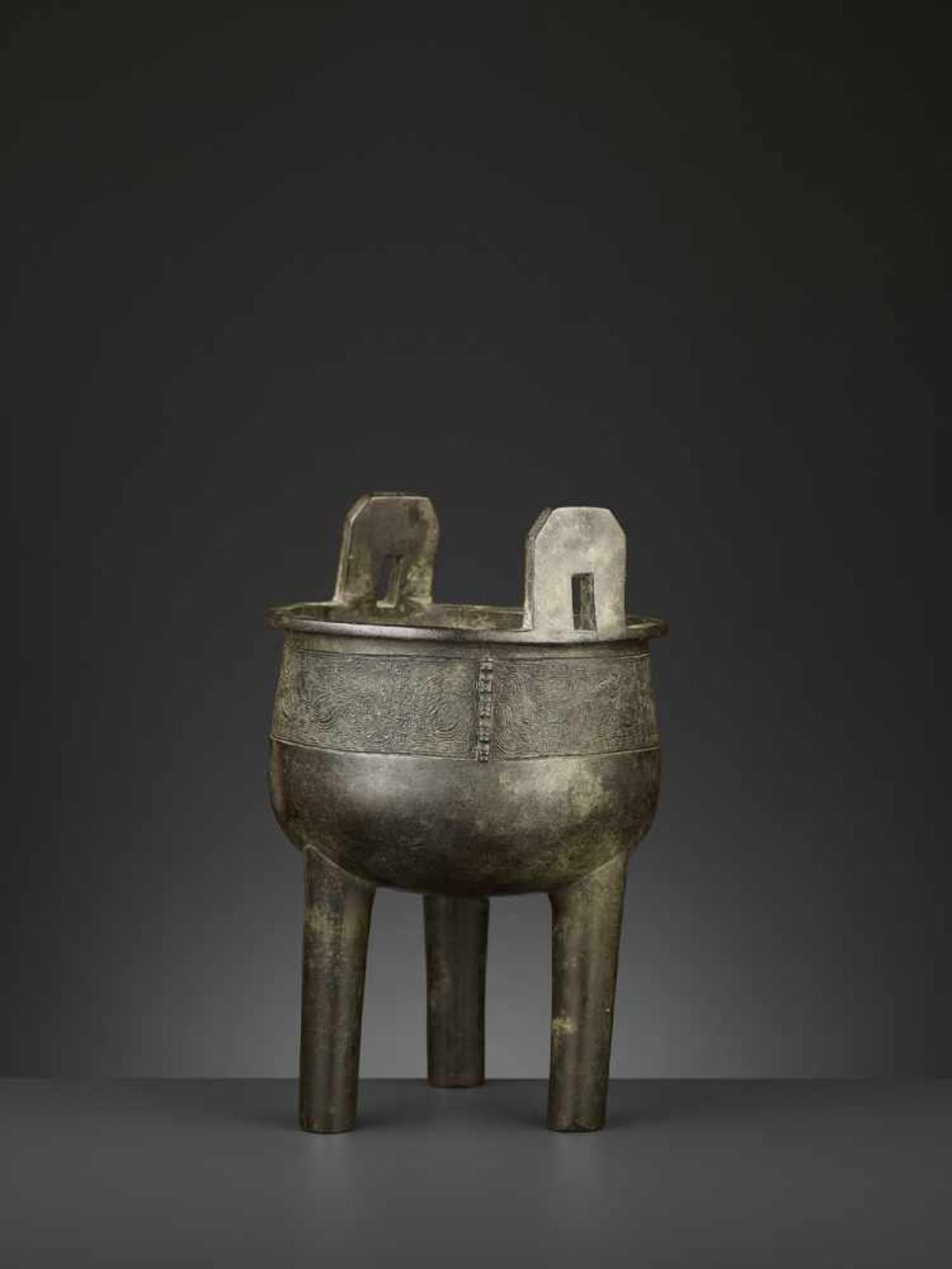 AN ARCHAISTIC BRONZE CENSER, DING China, 17th-18th century. The deep, bowl-shaped body supported - Image 2 of 10