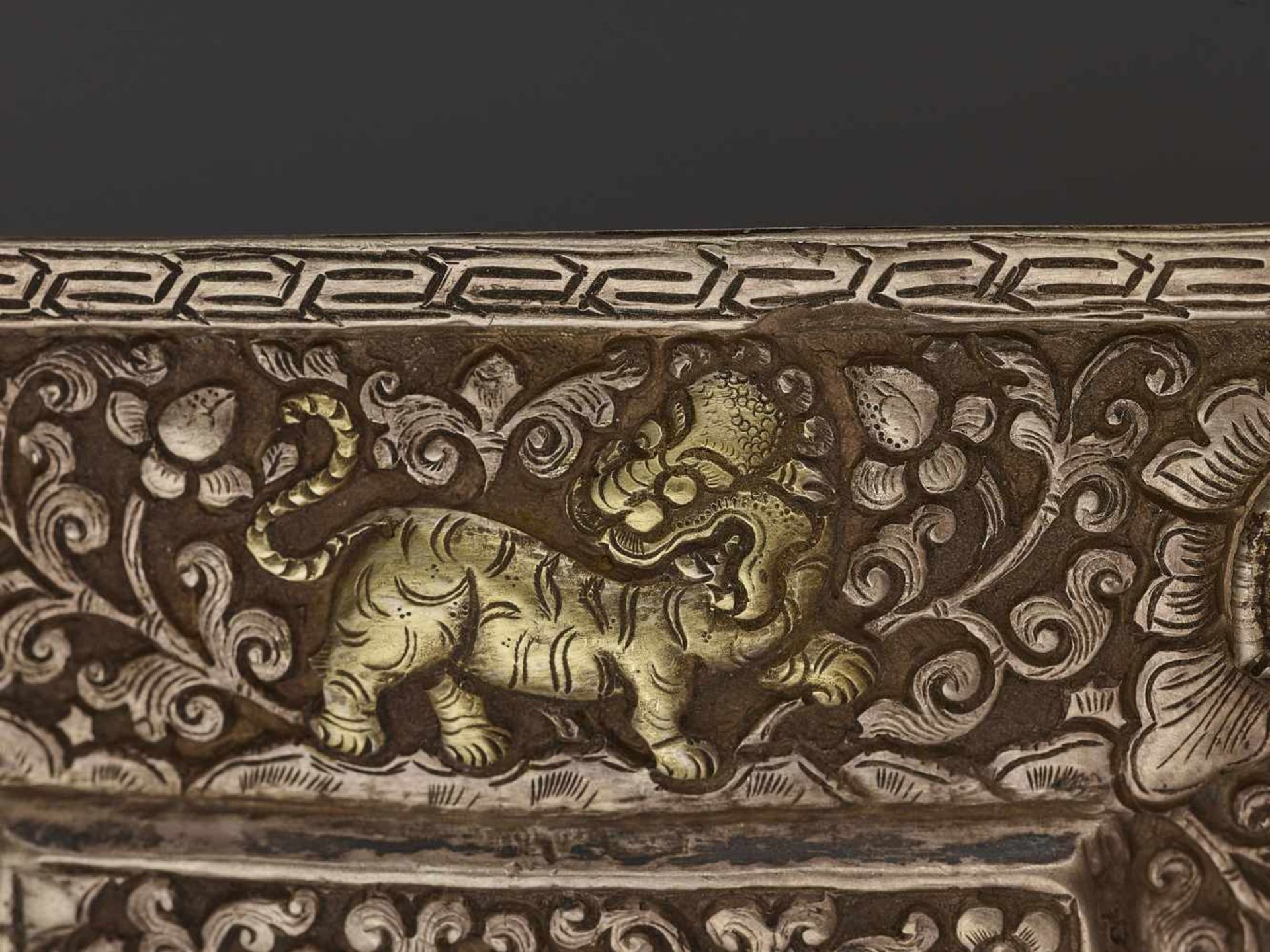 A SILVER REPOUSSÉ MANUSCRIPT COVER Tibet, late 18th – earlier 19th century. A gilt Buddha Shakyamuni - Image 3 of 5