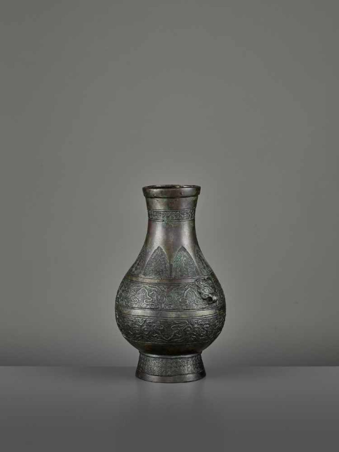 A BRONZE RITUAL VASE, HU China, Ming dynasty (1368-1644) or earlier. The archaistic vessel is cast