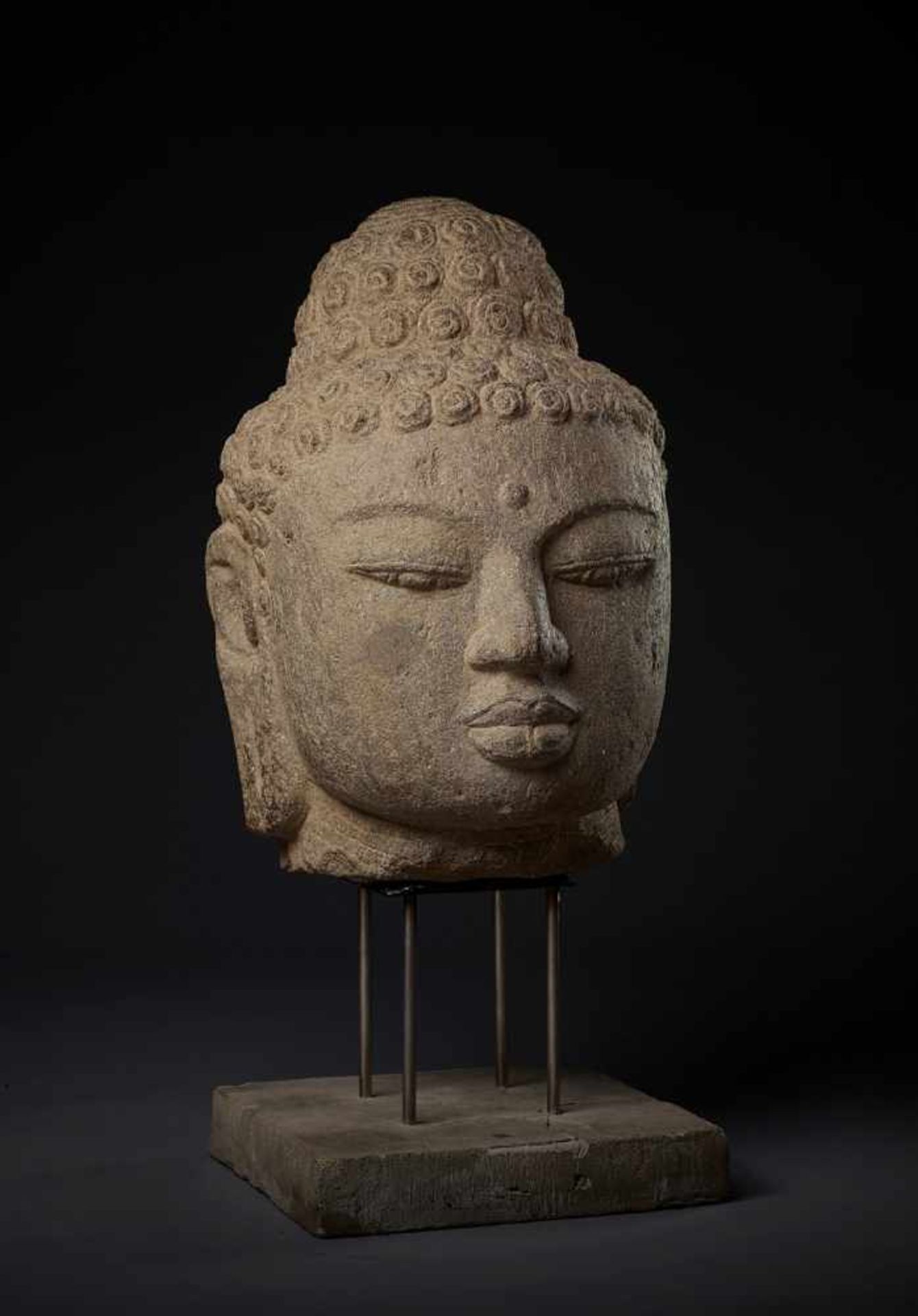 A LARGE AND IMPORTANT ANDESITE HEAD OF BUDDHA Indonesia, Central Java, 9th-10th century. Finely