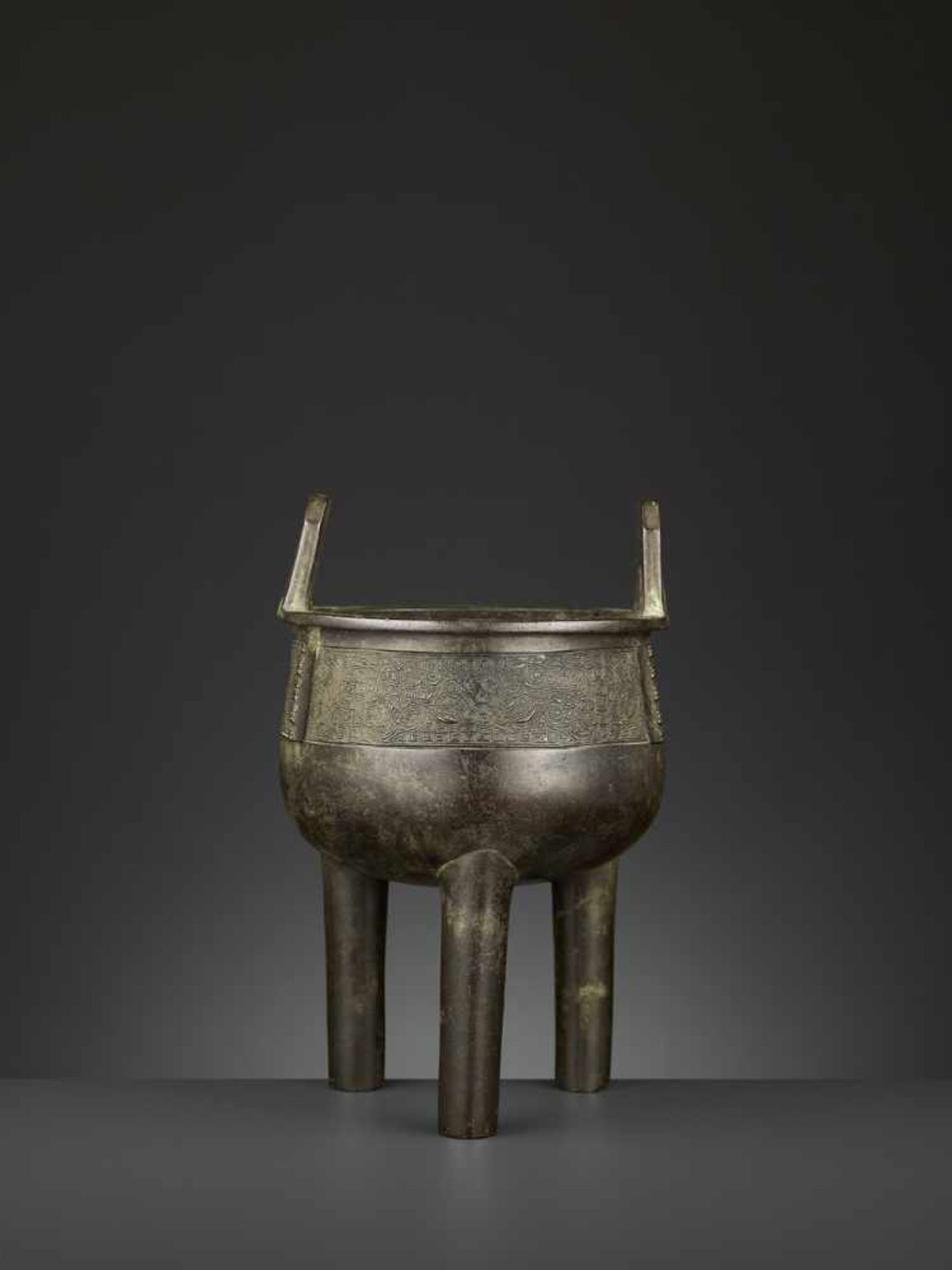 AN ARCHAISTIC BRONZE CENSER, DING China, 17th-18th century. The deep, bowl-shaped body supported