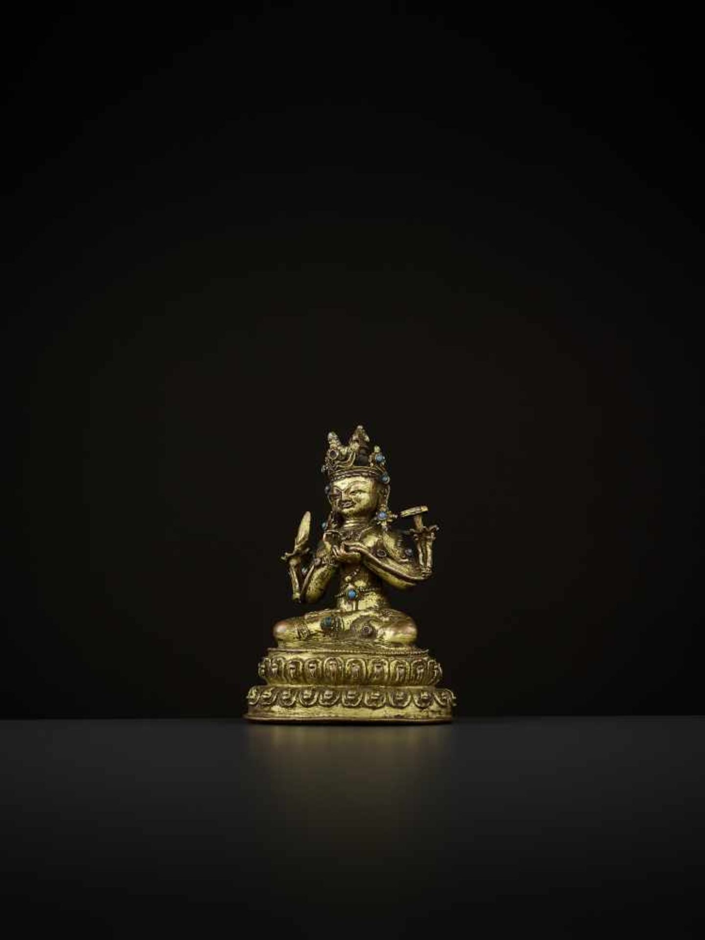 A GILT-BRONZE OF MANJUSHRI Tibet, 14th-15th century. The bodhisattva is seated in vajrasana on a - Image 2 of 9