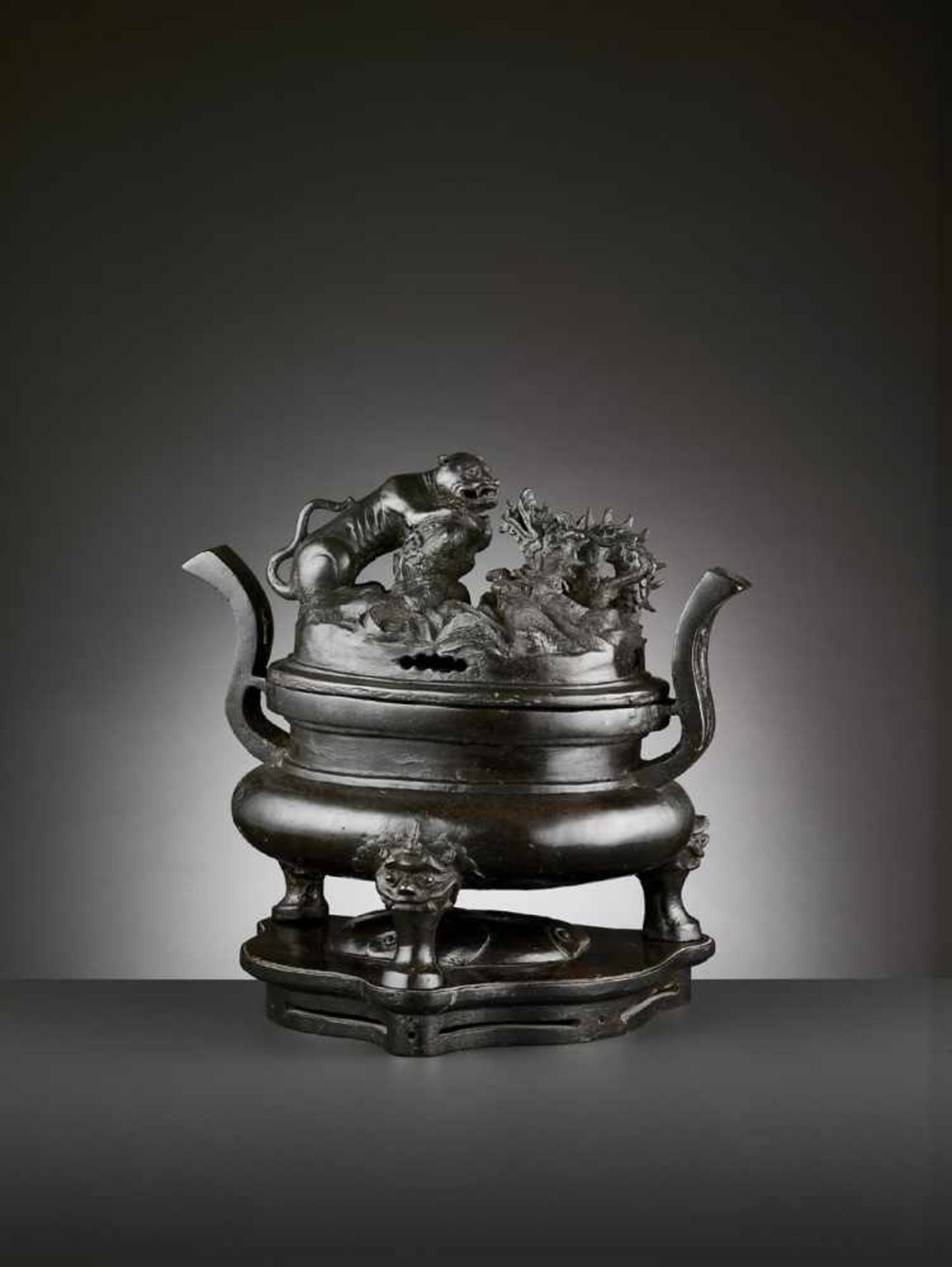 A LARGE BRONZE TRIPOD CENSER AND COVER, MING China, 16th-17th century. The bombé body is raised on