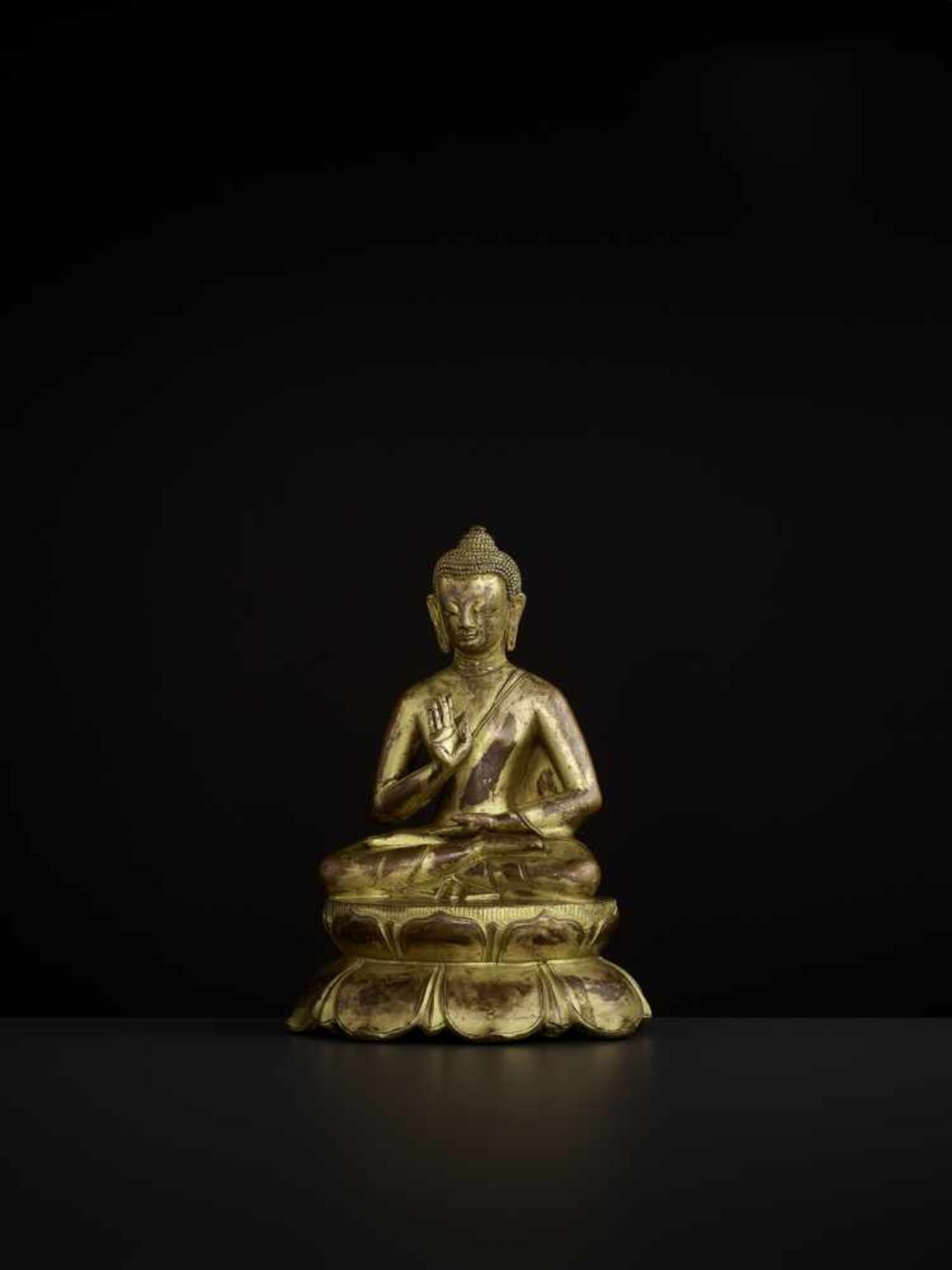 A BUDDHA AMOGHASIDDHI, NEPAL 17TH CENTURY The heavily cast gilt copper-alloy figure is seated in - Image 3 of 14