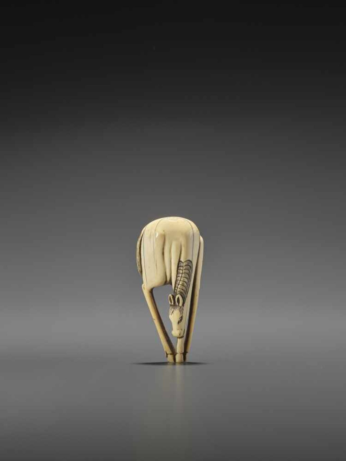 A LARGE AND RARE IVORY NETSUKE OF A GRAZING HORSE UnsignedJapan, 18th century, Edo period (1615-