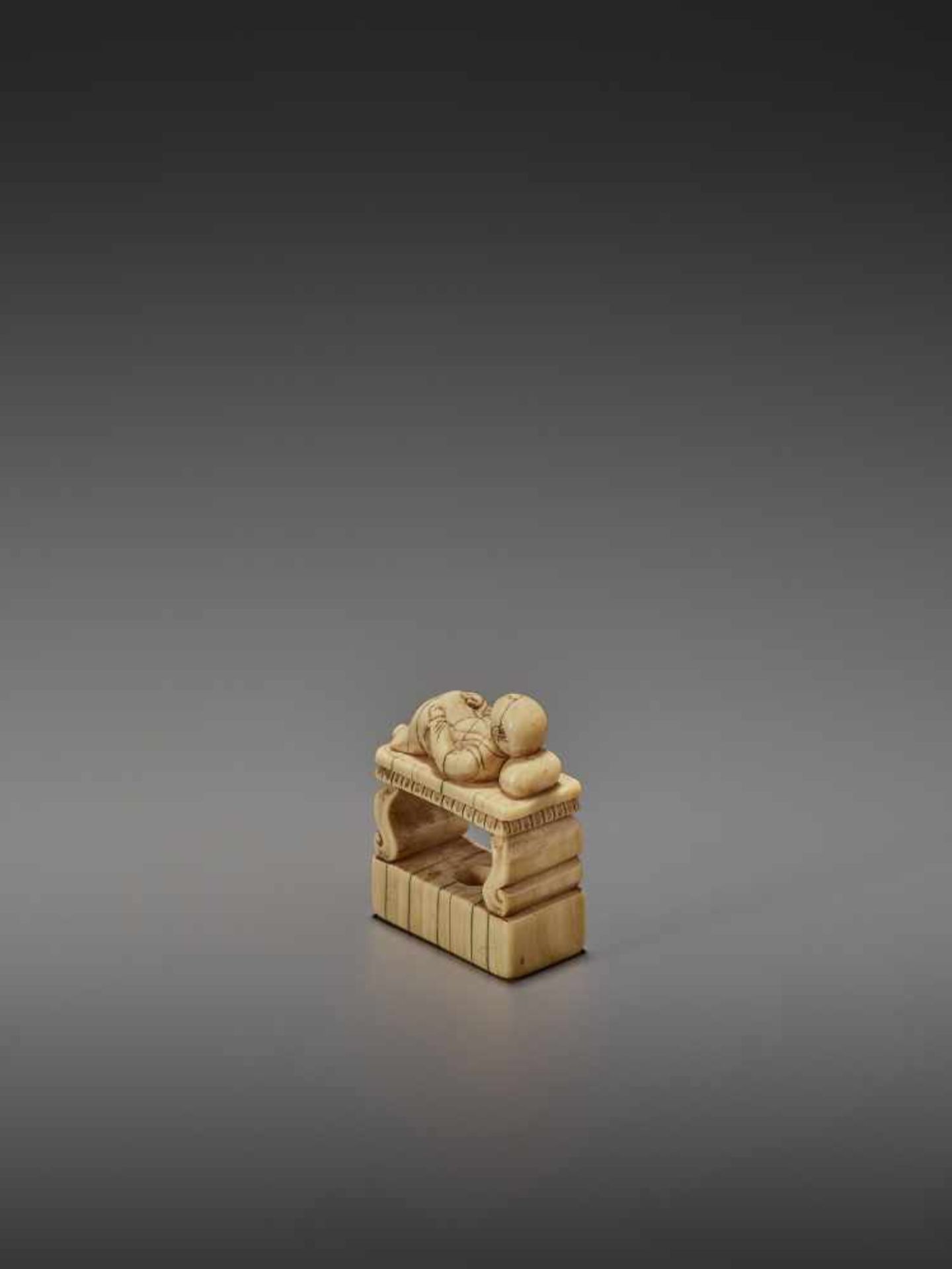 AN EARLY IVORY NETSUKE OF A CHINESE MAN SLEEPING ON AN OPIUM BED UnsignedJapan, early 18th - Image 6 of 11