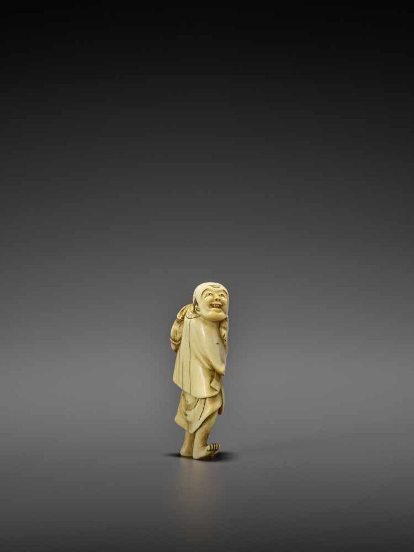AN IVORY NETSUKE OF A PERSIMMON MERCHANT UnsignedJapan, early 19th century, Edo period (1615-1868) - Image 7 of 10