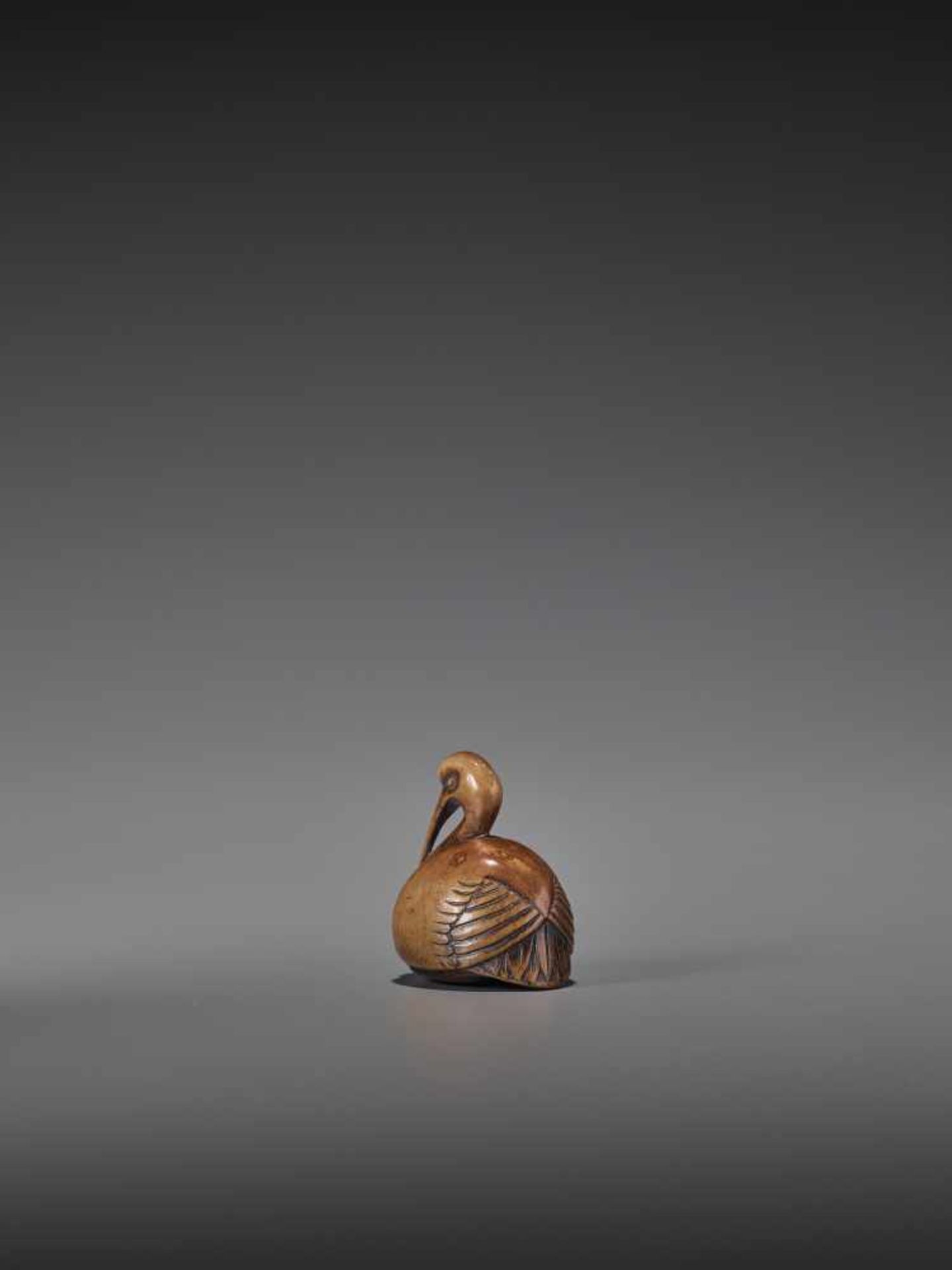 A RARE AND ELEGANT WOOD NETSUKE OF A CRANE UnsignedJapan, 18th century, Edo period (1615-1868)A wood - Image 2 of 8