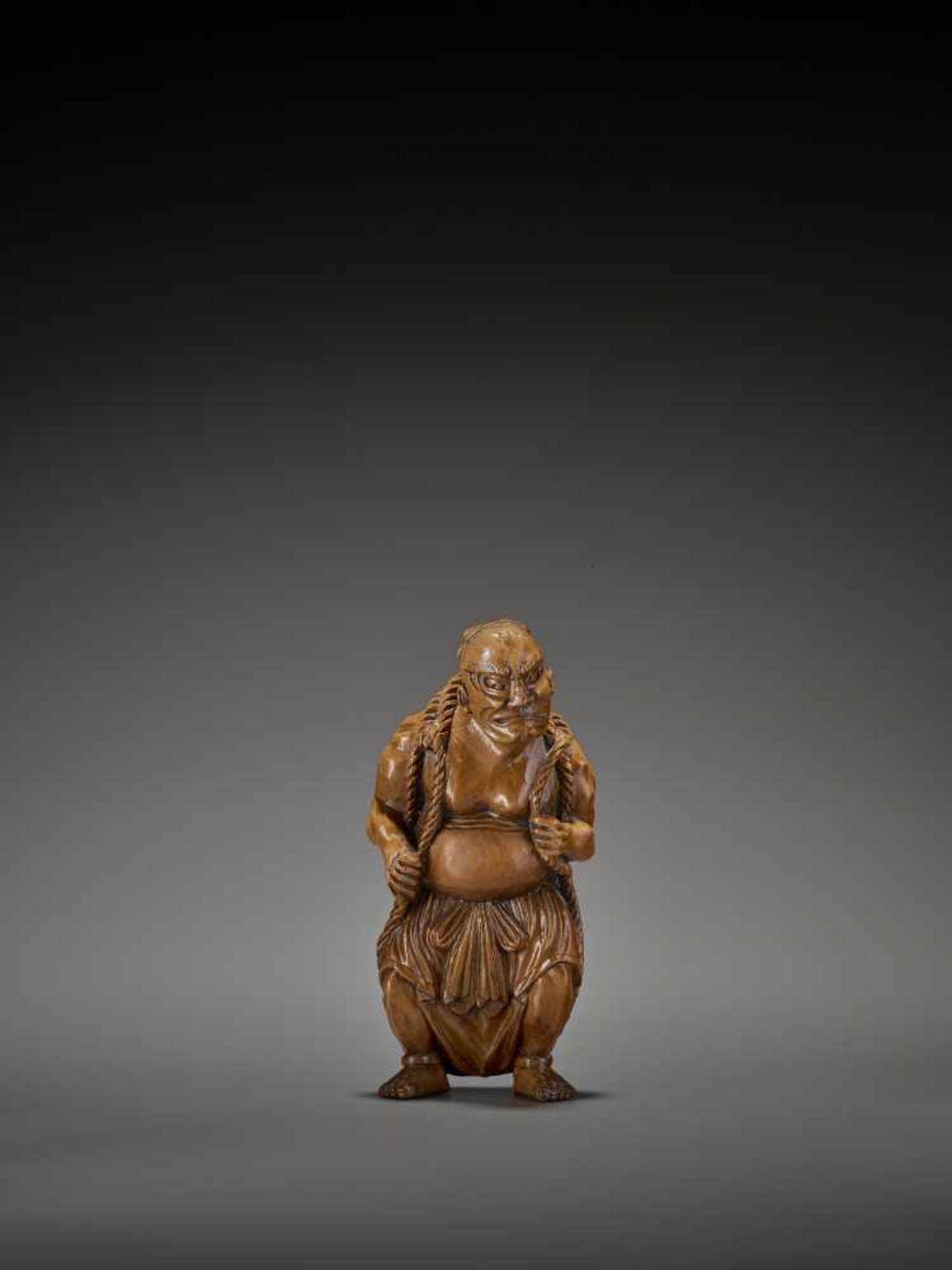 A RARE AND GIGANTIC ACTOR’S WOOD NETSUKE OF A NIO WITH WARAJI UnsignedJapan, 19th century, Edo